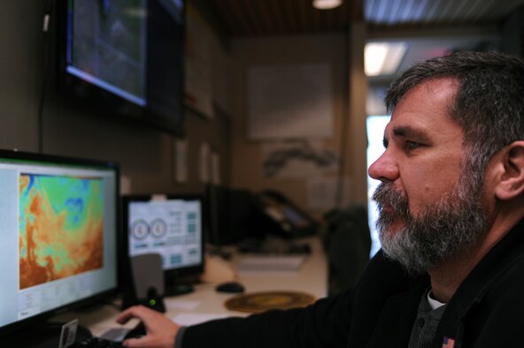 Willie Martin, 28th Operations Support Squadron weather flight lead forecaster, checks constant pressure charts at Ellsworth Air Force Base, S.D., Jan. 8, 2015. The chart presents a snapshot of high and low pressure systems and their proximity to one another, and allows forecasters to predict wind strength. (U.S. Air Force photo by Senior Airman Hailey R. Staker/Released)