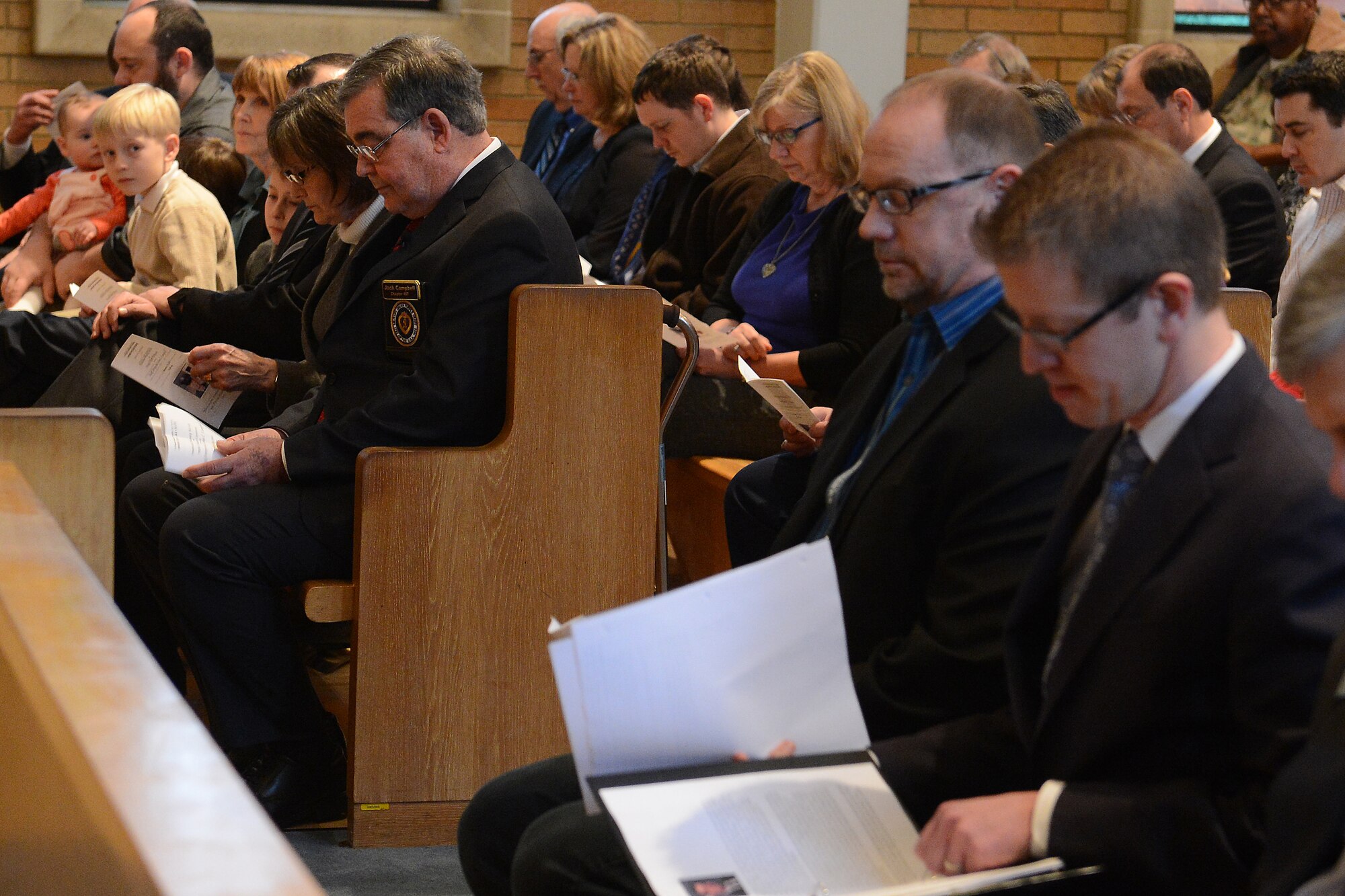 Staff Sgt. John Campbell, Air Force veteran, listens to speakers during his Purple Heart presentation Jan. 25, 2015 at American Lake Chapel, Lakewood, Wash. After 45 years of waiting Campbell received his medal for injuries sustained in Laos, Jan. 1, 1970. (U.S. Air Force photo\ Staff Sgt. Tim Chacon)