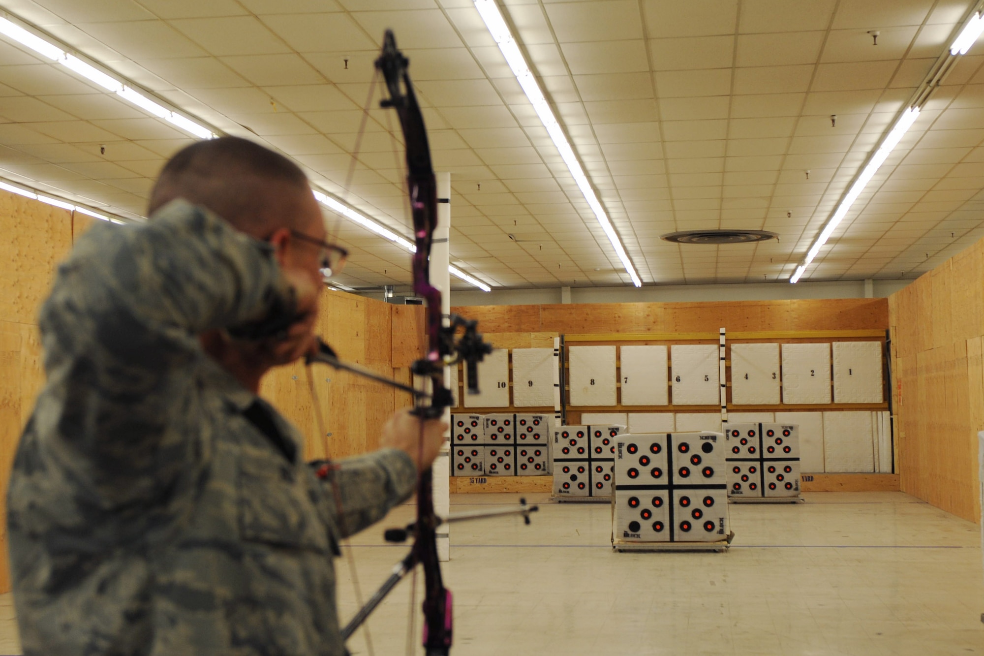 Master Sgt. Jack Rick, 28th Maintenance Group wing avionics manager, draws his bow in the Doolittle Indoor Archery Range at Ellsworth Air Force Base, S.D., Jan. 15, 2014. Members of the Ellsworth Rod and Gun Club receive free 24-hour access to the range, which offers four stationary 35-yard targets, eight lanes of movable targets, and two stationary 10-yard youth targets. (U.S. Air Force photo by Airman 1st Class Anania Tekurio/Released) 