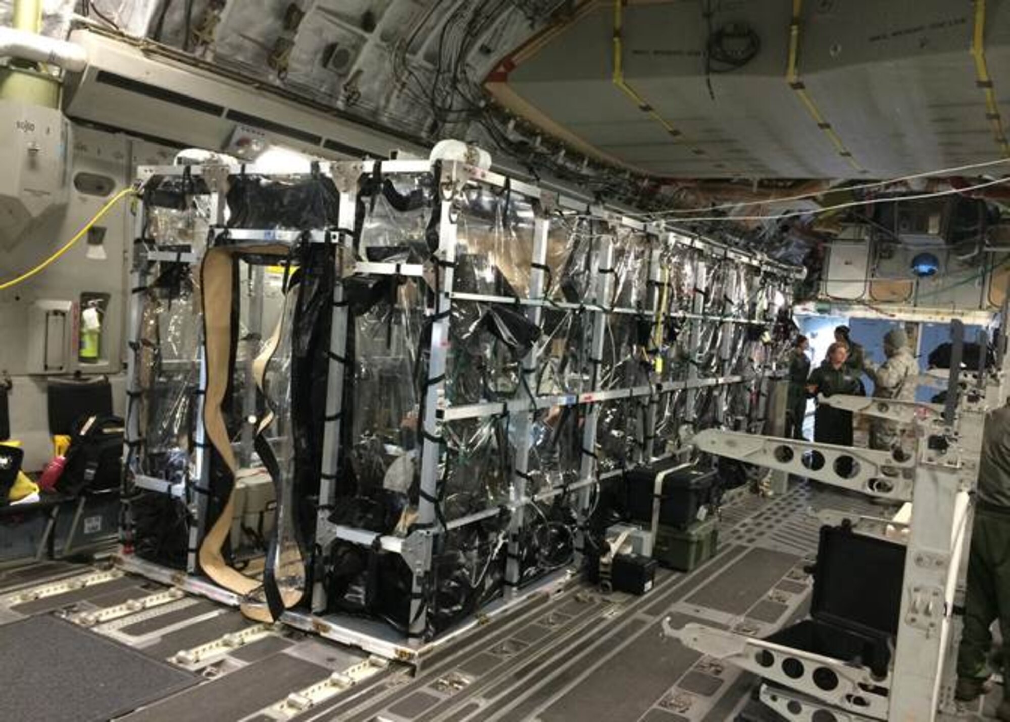 Airmen from Joint Base Charleston and the Air Force Operational Test and Evaluation Center build, test and evaluate the Transport Isolation System (TIS) at JB Charleston, Dec. 13, 2014. The TIS is a self-contained module system that can be used with either two or three sections, depending on aircraft space. It will be used to safely transport patients with an infectious disease. (U.S. Air Force photo by Chief Master Sgt. Bryan DuBois )