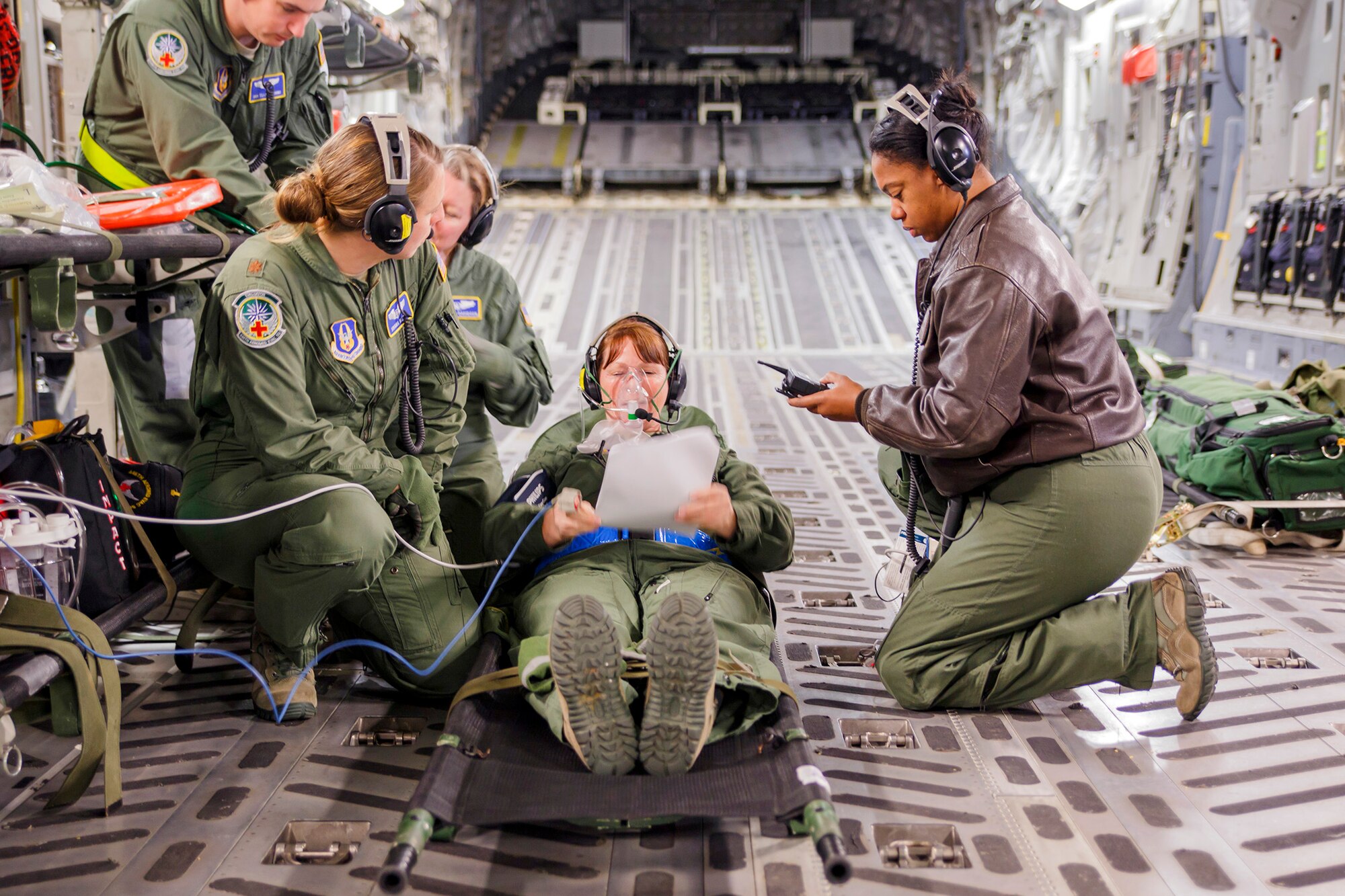 Medical professionals from the Air Force Reserve's 446th Aeromedical Evacuation Squadron here at Joint Base Lewis-McChord, treat a "patient" during a training scenario on a McChord Field C-17 Globemaster III aircraft during the unit's in-flight medical training, Jan. 21, 2015. The 2,100 men and women assigned to the 446th AW support the Air Mobility Command (AMC) mission around the world on a daily basis, performing 44 percent of all C-17 missions leaving JBLM.
(U.S. Air Force Reserve photo by Jake Chappelle)