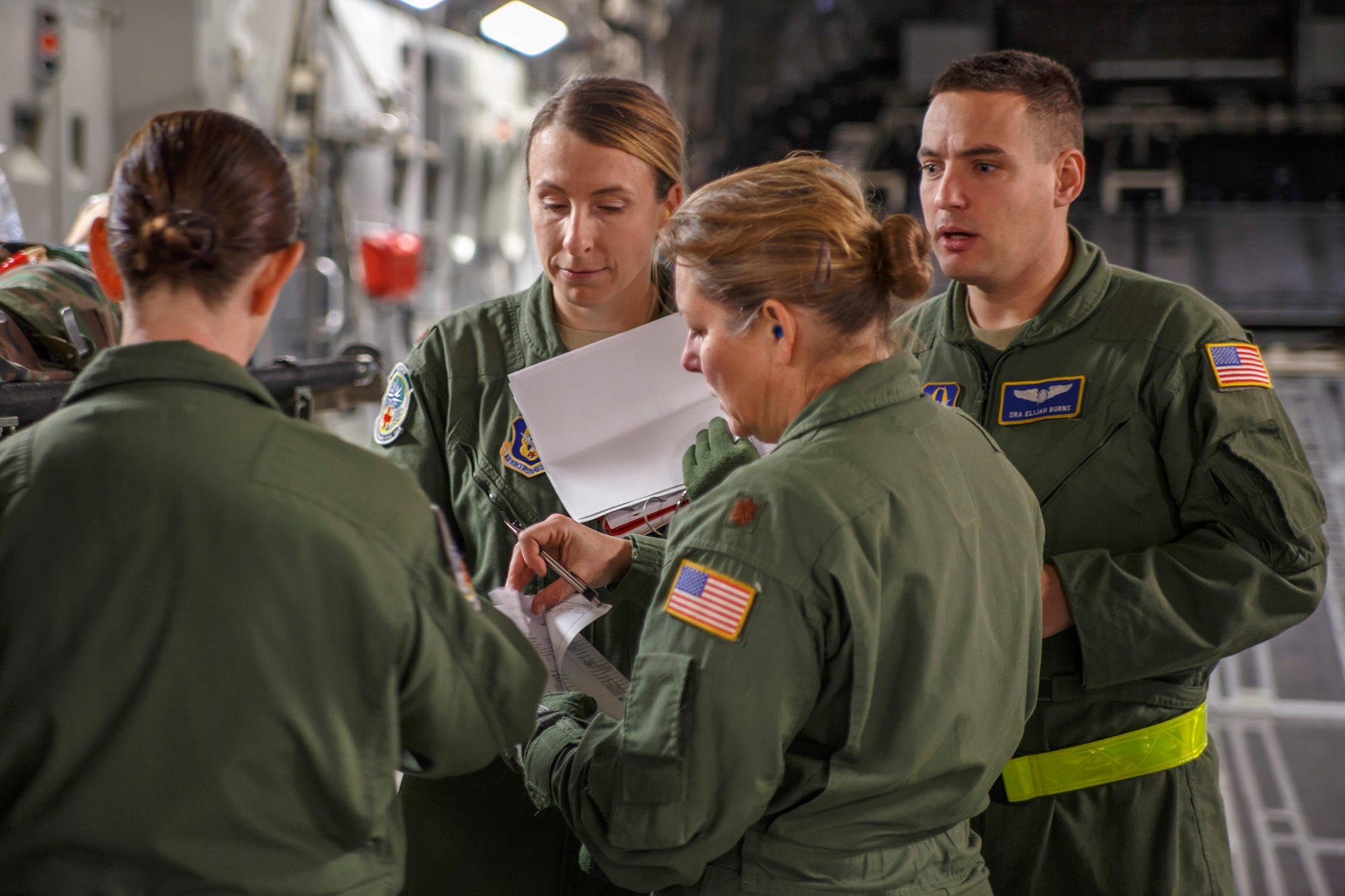 Air Force Reserve Maj. Shana Weber (center), a flight nurse with the 446th Aeromedical Evacuation Squadron here at Joint Base Lewis-McChord, and members from her team review a training scenario on a McChord Field C-17 Globemaster III transport aircraft during the unit's in-flight medical training, Jan. 21, 2015. The 2,100 men and women assigned to the 446th AW support the Air Mobility Command (AMC) mission around the world on a daily basis, performing 44 percent of all C-17 missions leaving JBLM. (U.S. Air Force Reserve photo by Jake Chappelle)