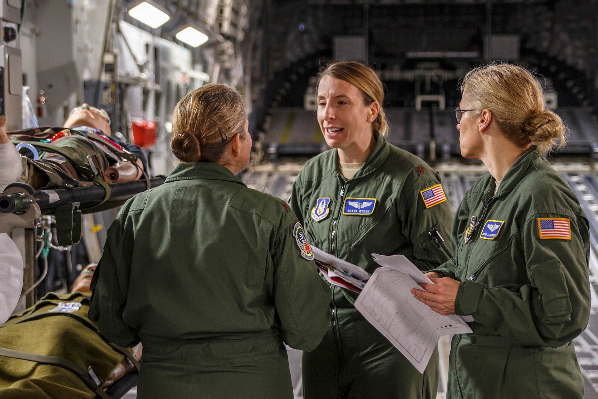 Air Force Reserve Maj. Shana Weber (center), a flight nurse with the 446th Aeromedical Evacuation Squadron here at Joint Base Lewis-McChord, goes over a training scenario with members from her team on a McChord Field C-17 Globemaster III transport aircraft during the unit's in-flight medical training, Jan. 21, 2015. The 2,100 men and women assigned to the 446th AW support the Air Mobility Command (AMC) mission around the world on a daily basis, performing 44 percent of all C-17 missions leaving JBLM. (U.S. Air Force Reserve photo by Jake Chappelle)