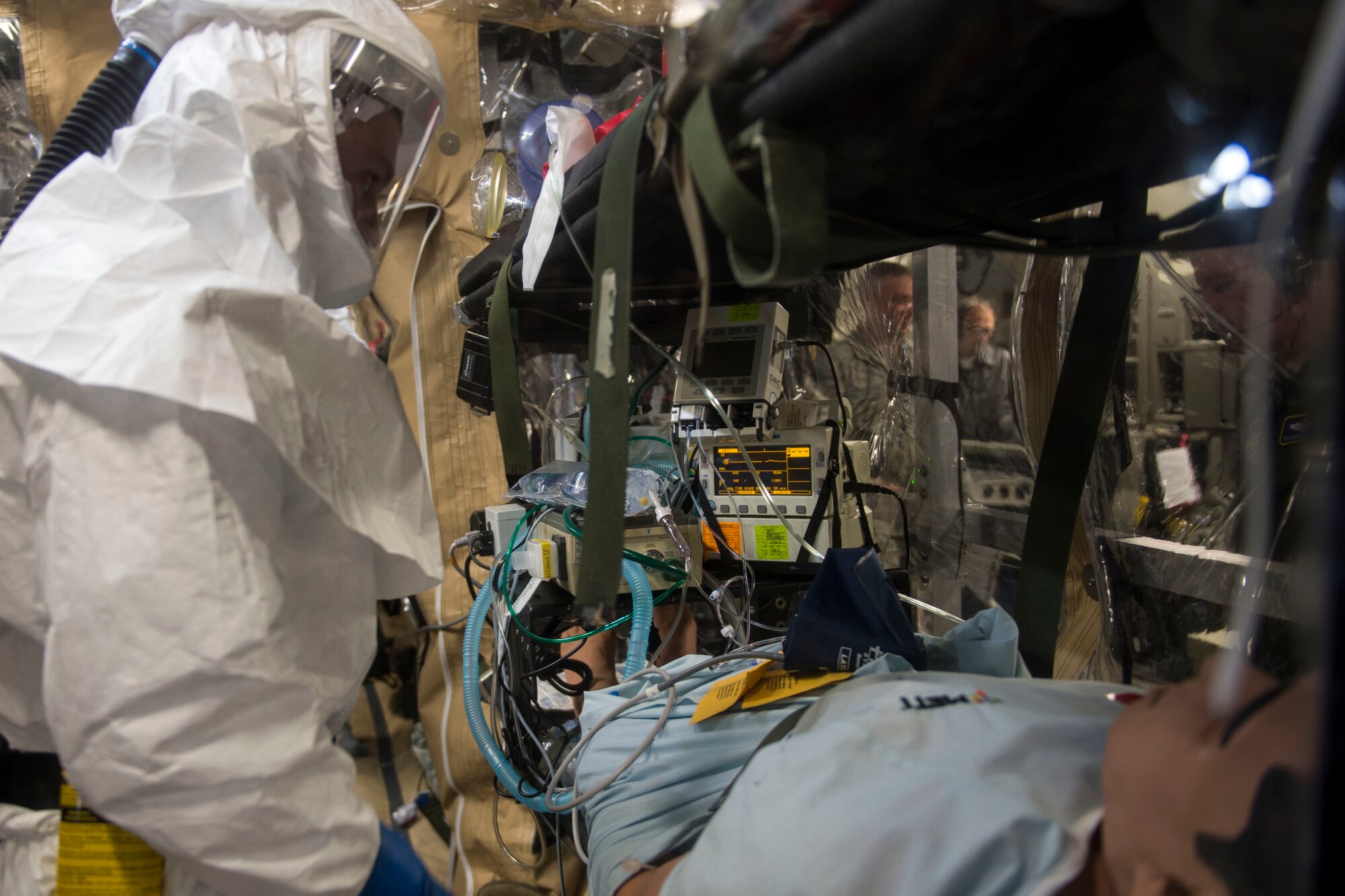 Airmen from Joint Base Charleston and the Air Force Operational Test and Evaluation Center build, test and evaluate the Transport Isolation System (TIS) at JB Charleston, Dec. 13, 2014. The TIS is a self-contained module system that can be used with either two or three sections, depending on aircraft space. It will be used to safely transport patients with an infectious disease. (U.S. Air Force photo by Airman 1st Class Taylor Queen/Released)