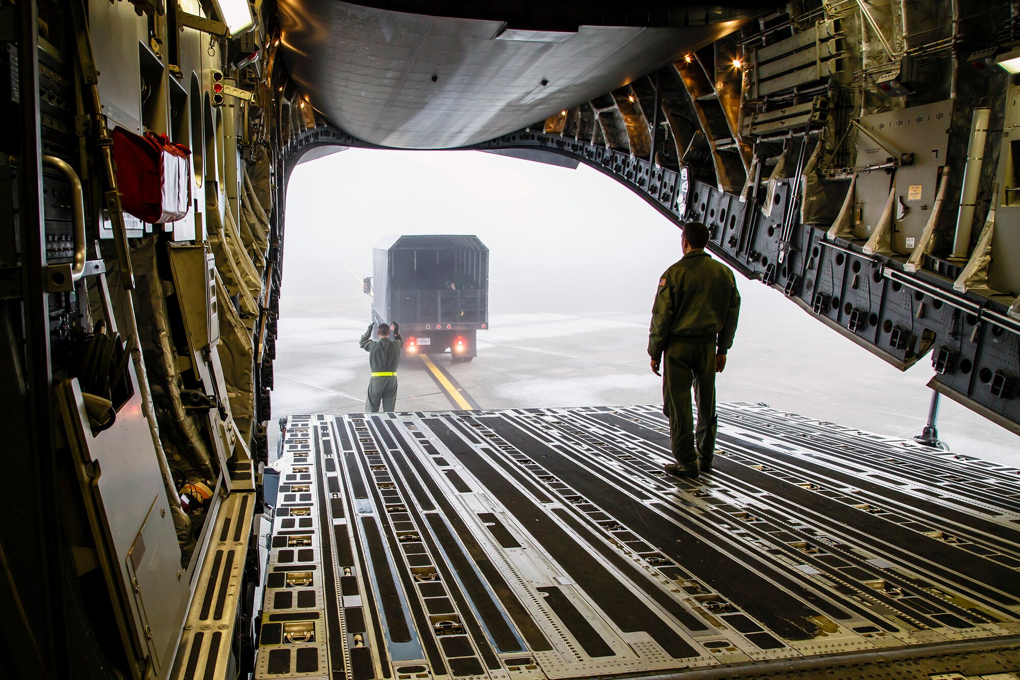 A cargo truck full of medical treatment equipment is marshaled into the back of a McChord Field C-17 Globemaster III, Jan. 21, 2015. The equipment was for aeromedical evacuation in-flight training by the Air Force Reserve's 446th Aeromedical Evacuation Squadron here. The 2,100 men and  women assigned to the 446th Airlift Wing support the Air Mobility Command (AMC) mission around the world on a daily basis, performing 44 percent of all C-17 missions leaving JBLM.
(U.S. Air Force Reserve photo by Jake Chappelle)