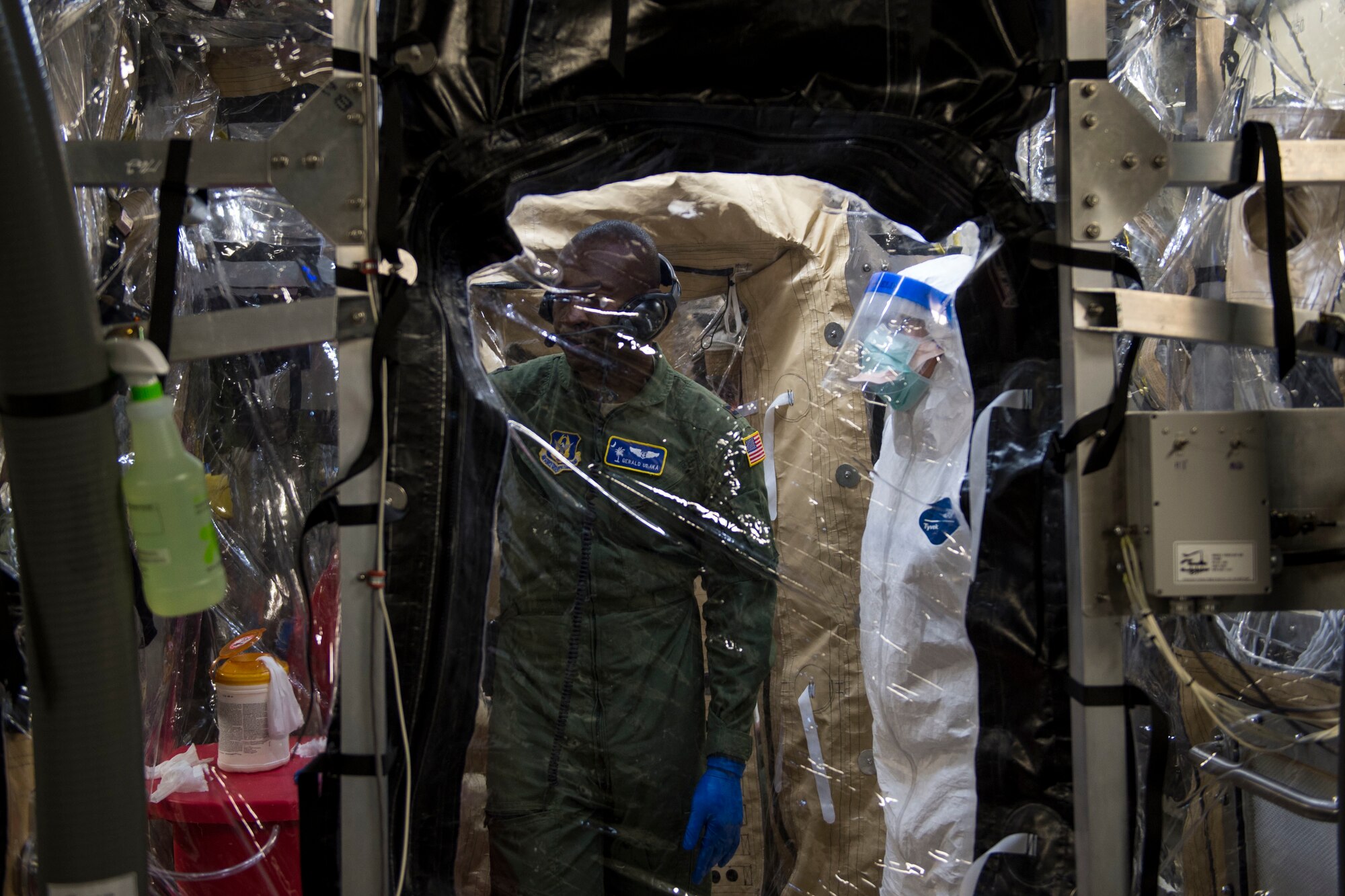 Capt. Gerald Ubaka, 315th Aeromedical Evacuation Squadron flight nurse, joins Airmen from Joint Base Charleston and the Air Force Operational Test and Evaluation Center build, test and evaluate the Transport Isolation System (TIS) at JB Charleston, Dec. 13, 2014. The TIS is a self-contained module system that can be used with either two or three sections, depending on aircraft space. It will be used to safely transport patients with an infectious disease. (U.S. Air Force photo by Airman 1st Class Taylor Queen/Released)