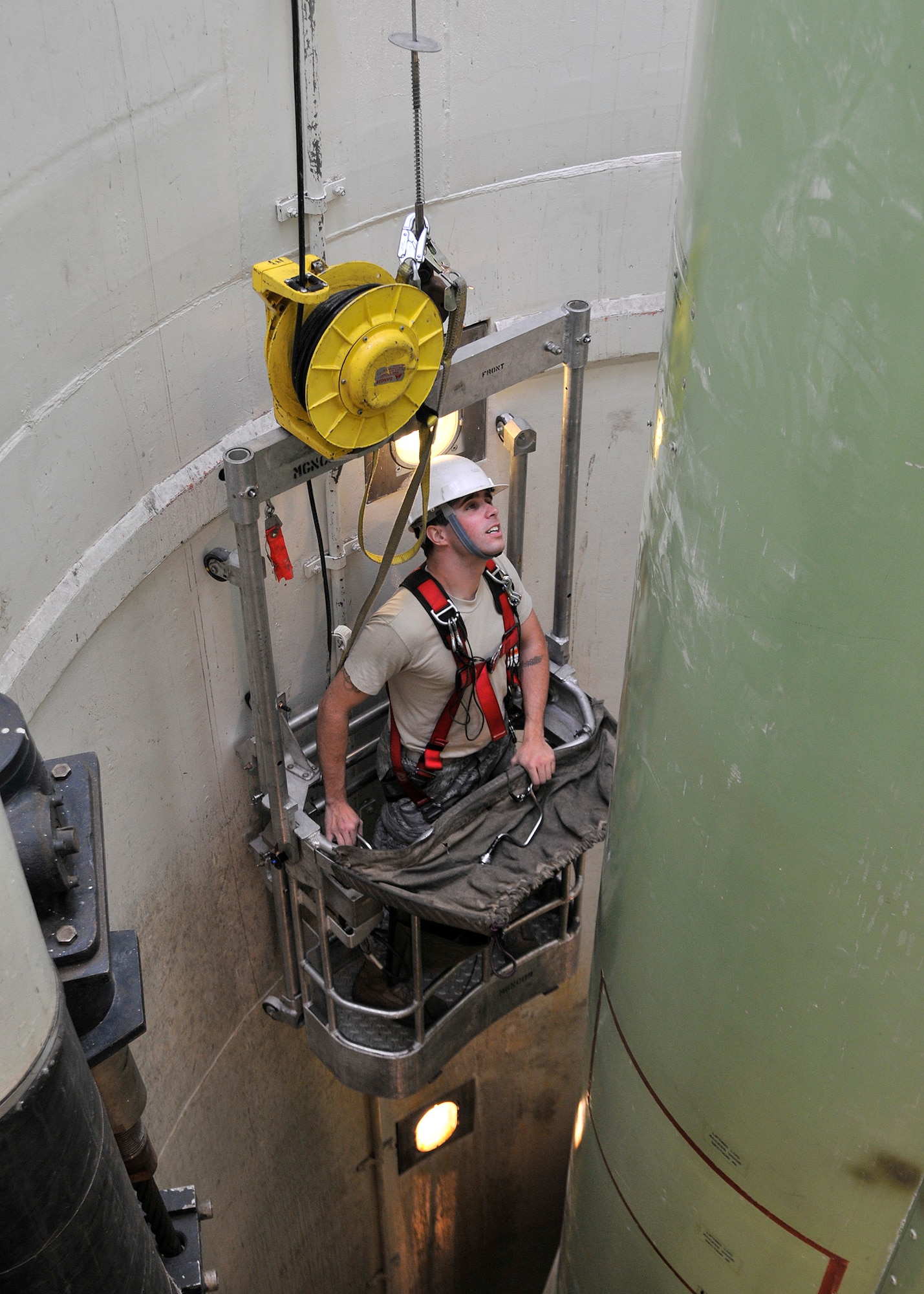 Staff Sgt. Isaiah Miller, 341st Missile Maintenance Squadron, operates a guided missile maintenance platform May 7, 2010, to navigate around a mock-up of a Minuteman III missile at Malmstrom Air Force Base’s T-9 launch facility maintenance trainer during a maintenance exercise. (U.S. Air Force photo/John Turner)