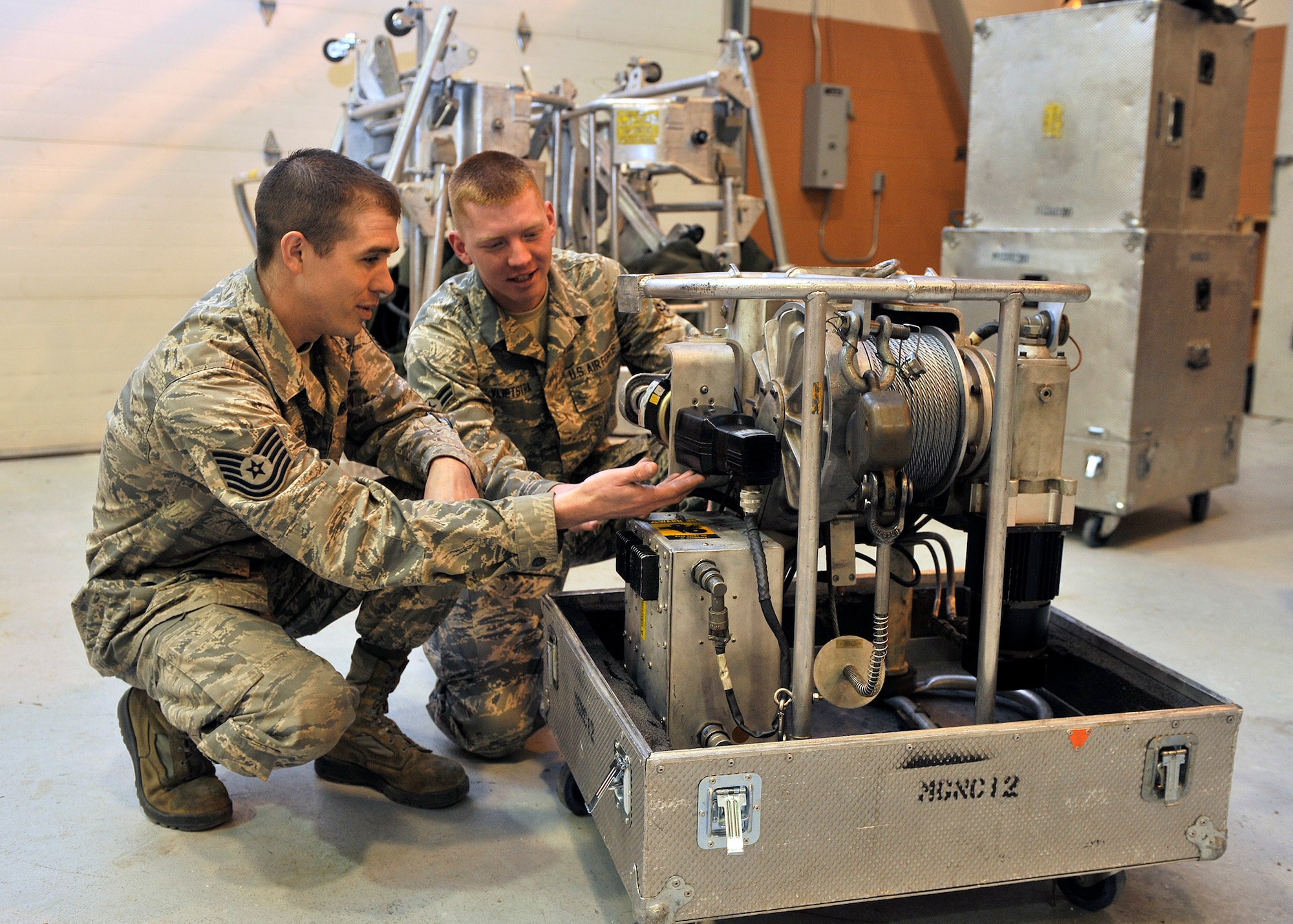 Tech. Sgt. Robert Richards, 341st Maintenance Operations Squadron mechanical and pneudraulics section team chief and team trainer, and Airman 1st Class Benjamin Vlietstra, 341st MOS power, refrigeration and electrical laboratory technician, look over a guided missile maintenance platform motor Jan. 21 at Malmstrom Air Force Base, Mont. All 17 of the 341st Missile Wing’s GMMPs—also known as work cages—were available for service at Jan. 14, ensuring that missile maintenance in Minuteman III launch facilities stays on schedule. (U.S. Air Force photo/John Turner)