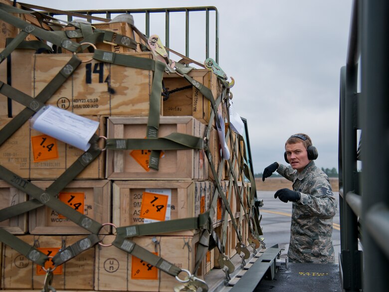 Tech. Sgt. Christopher Cope, 96th Logistics Readiness Squadron, helps guide in an ammunition pallet onto a carrier Jan. 13 at Duke Field, Fla.  The LRS crew loaded more than 100,000 pounds of ammunition from the 7th Special Forces Group onto the C-17 Globemaster III during the upload.  (U.S. Air Force photo/Tech. Sgt. Sam King)
