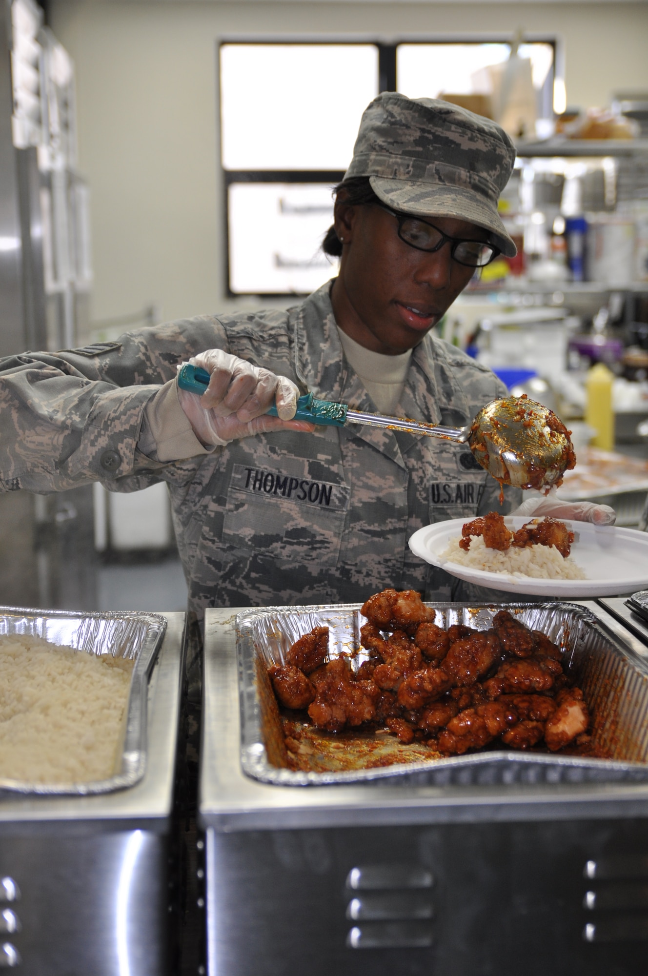 Air Force Reserve Senior Airman Franchisca Thompson, a Services Technician assigned to the 910th Force Support Squadron (FSS), serves the meal entree during lunch of the Unit Training Assembly here, Jan. 10, 2015. The 910th FSS provides leadership and supervision of support services to the 910th Airlift Wing through the Military Personnel Section, Wing Education & Training and Family Support sections. The squadron exercises overall direction and control over contingency operation for deploy/redeployment and in wartime, provides personnel account-ability/reporting, force management and casualty reporting at established and bare bases. Additionally, the 910th FSS trains and equips personnel to meet wartime requirements. The squadron also provides combat support for Air Force operational forces in food service, lodging, mortuary affairs, fitness, field exchange, recreation activities and self-help laundries. U.S. Air Force photo by Tech. Sgt. Valerie Smock.