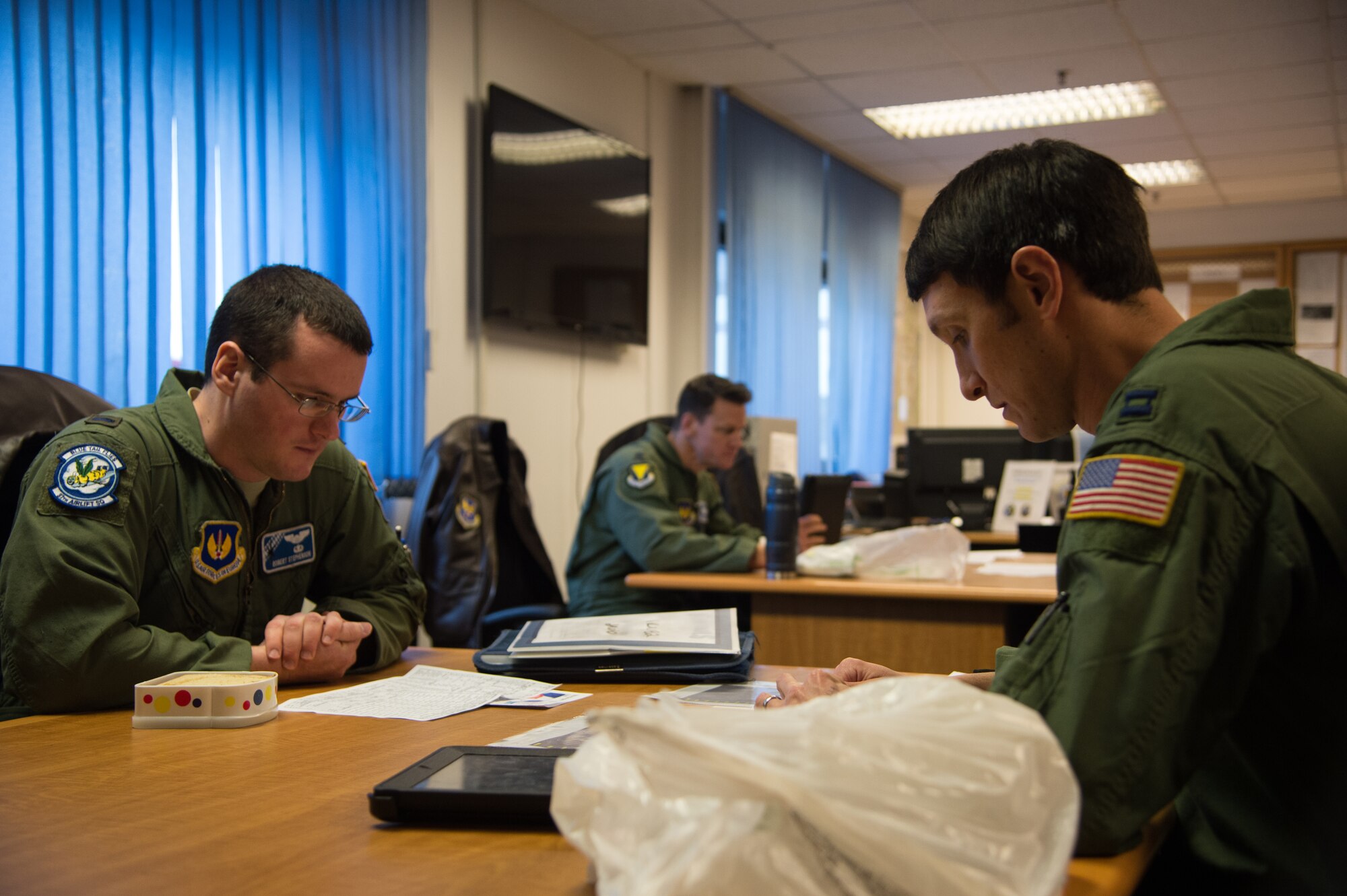 First Lt. Robert Stephenson and Capt. Kenneth Jubb, 37th Airlift Squadron pilots, go over mission planning Jan. 22, 2015, at Ramstein Air Base, Germany. The intent of the mission was to train the pilots in flying at 7,000 feet as well as performing a simulated cargo drop to maintain proficiency. (U.S. Air Force photo/Senior Airman Jonathan Stefanko)