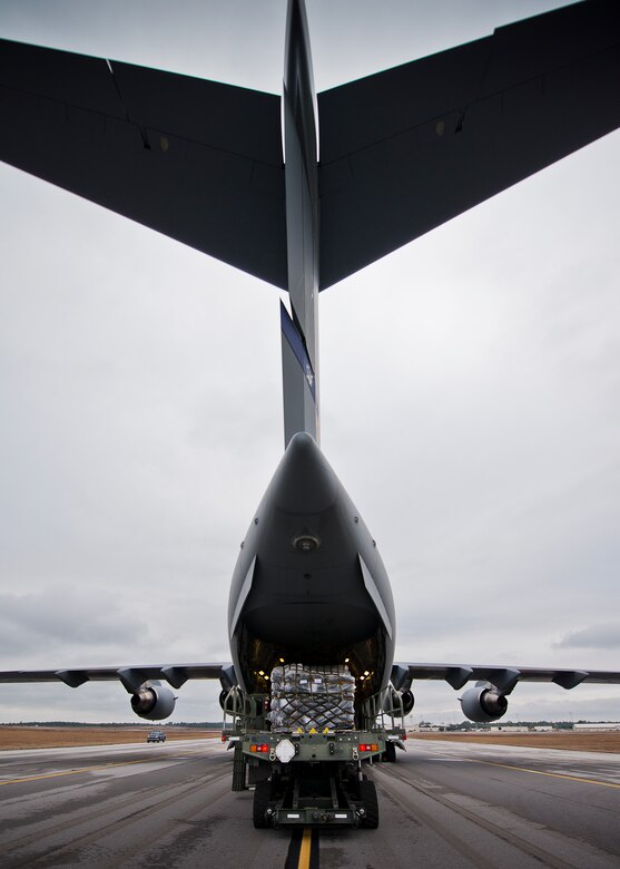 A pallet loader moves into place to begin unloading its cargo onto a C-17 Globemaster III Jan. 13 at Duke Field, Fla.  The 96th Logistics Readiness Squadron’s aerial operations crew loaded more than 100,000 pounds of ammunition from the 7th Special Forces Group onto the aircraft during the upload.  (U.S. Air Force photo/Tech. Sgt. Sam King)