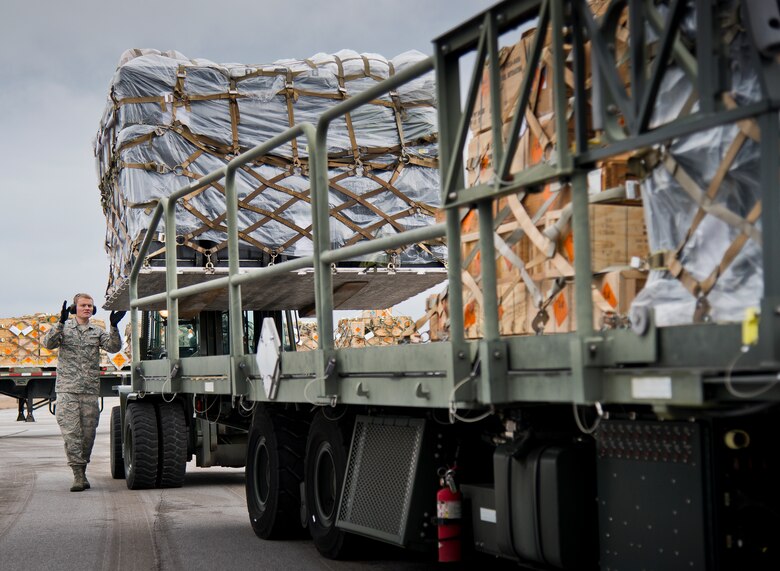Tech. Sgt. Christopher Cope, 96th Logistics Readiness Squadron, helps guide in an ammunition pallet onto a carrier Jan. 13 at Duke Field, Fla.  The LRS crew loaded more than 100,000 pounds of ammunition from the 7th Special Forces Group onto the C-17 Globemaster III during the upload.  (U.S. Air Force photo/Tech. Sgt. Sam King)