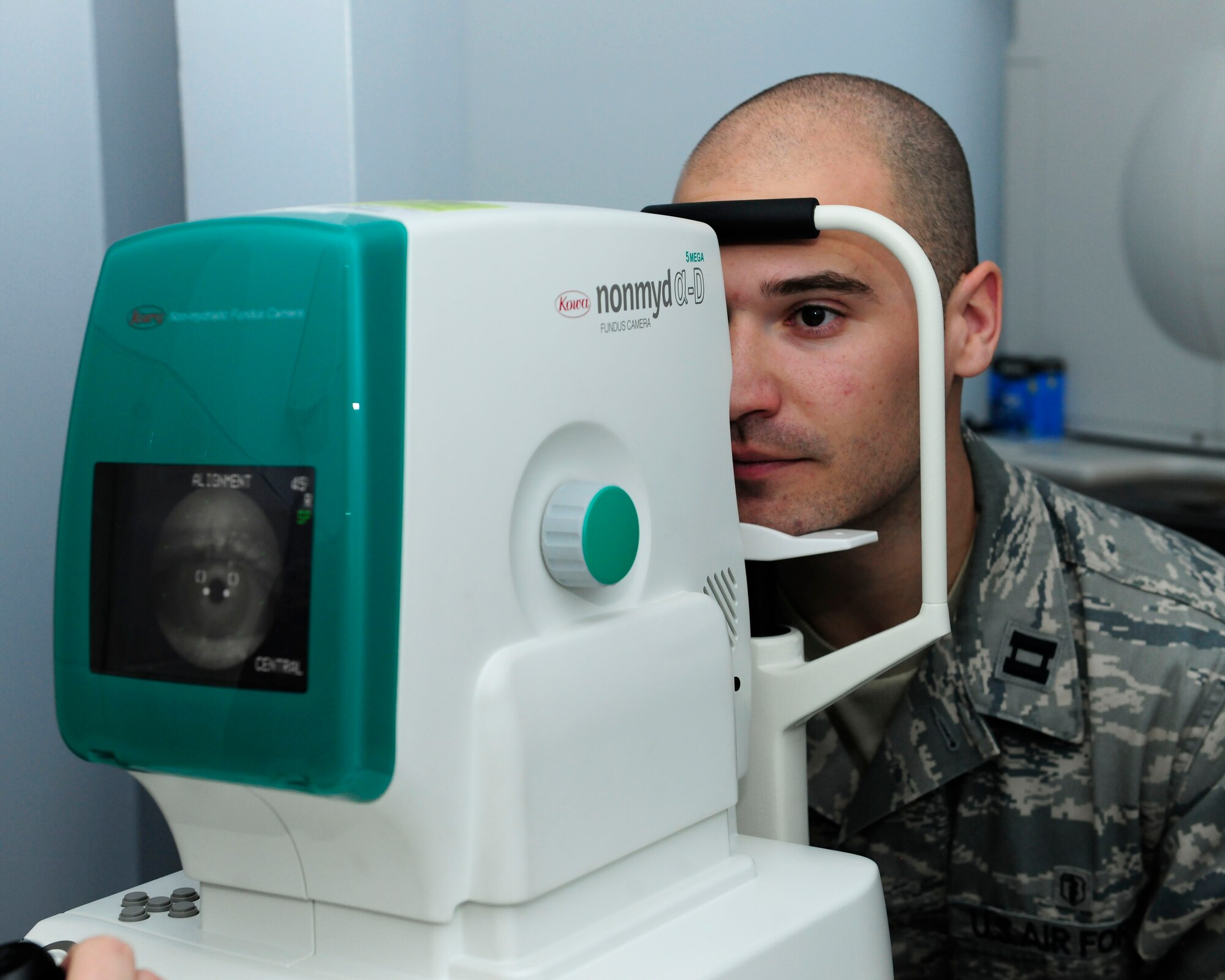 Capt. Brandon Harris, 39th Medical Group officer in charge of optometry, stands in as a patient to test a non-mydriatic fundus camera Jan. 21, 2015, at Incirlik Air Base, Turkey. The fundis camera is used to provide photo documentation of various ocular diseases. (U.S. Air Force photo by Senior Airman Krystal Ardrey/Released)