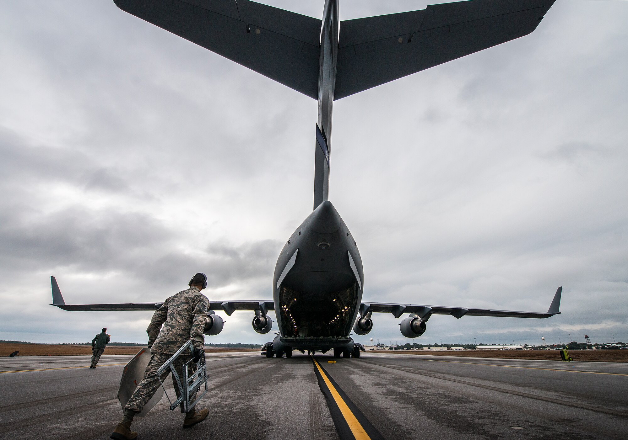 Tech. Sgt. Dominic Wimsatt, 96th Logistics Readiness Squadron, walks toward the just-parked 305th Air Mobility Wing C-17 Globemaster III after its arrival at Duke Field, Fla.  The aircrew picked up more than 100,000 pounds of ammunition from the 7th Special Forces Group during their stop.  (U.S. Air Force photo/Tech. Sgt. Sam King)