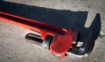 A wrench rests on the ground on Minot Air Force Base, N.D., Jan. 13, 2015. Airmen from the 5th Civil Engineer Squadron constructed a fueling station on the flightline for heavy equipment to be easily refueled. (U.S. Air Force photo/Airman 1st Class Sahara L. Fales)