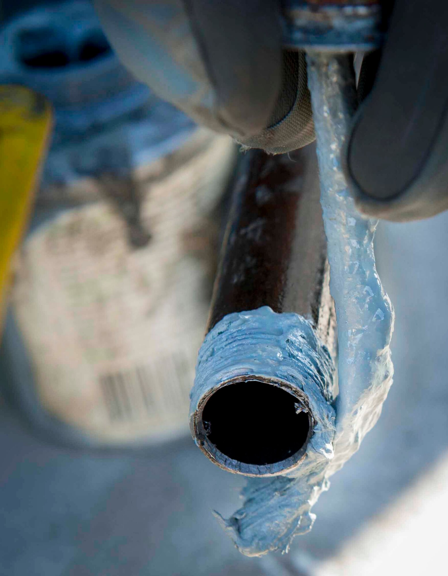 Pipe dough is placed on the end of a pipe on Minot Air Force Base, N.D., Jan. 13, 2015. Pipe dough is an element used to prevent seizing of pipes and also allows the pipes to be easily disconnected during maintenance. (U.S. Air Force photo/Airman 1st Class Sahara L. Fales)