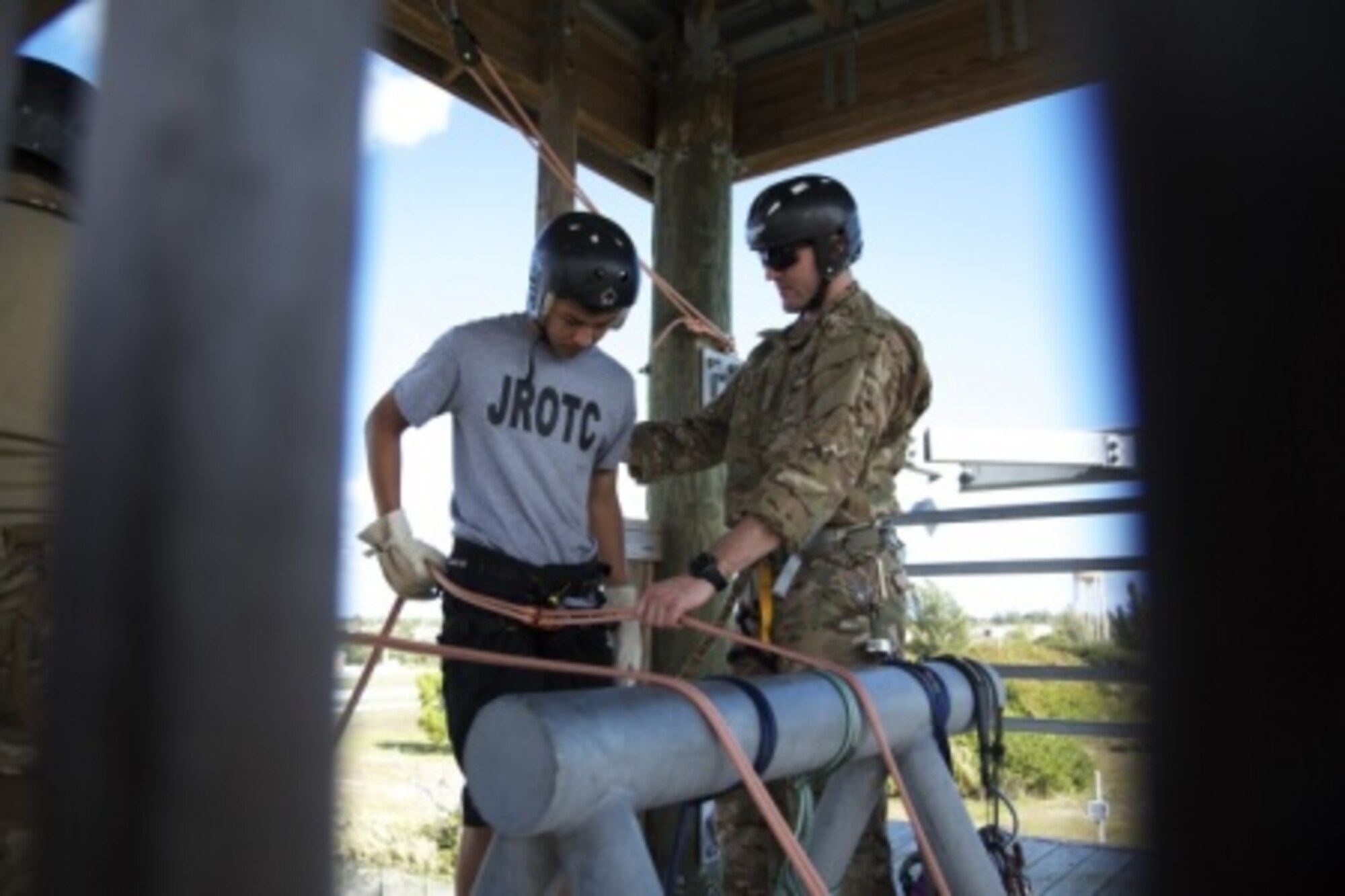 A U.S. Army Soldier assigned to Special Operations Command South prepares a Junior Reserve Officer Training Corps cadet from South Dade High School to rappel from a 50-foot tower Jan. 22 during a two-day mentorship event hosted by SOCSOUTH at Homestead Air Reserve Base, Fla. Other participating units during the event included service members from the 482nd Civil Engineer Squadron and EOD flight, the U.S. Coast Guard’s Maritime Safety Security Team Miami, and police officers with the Homestead Police Canine (K-9) Unit. (U.S. Army photo by Staff Sgt. Osvaldo Equite)
