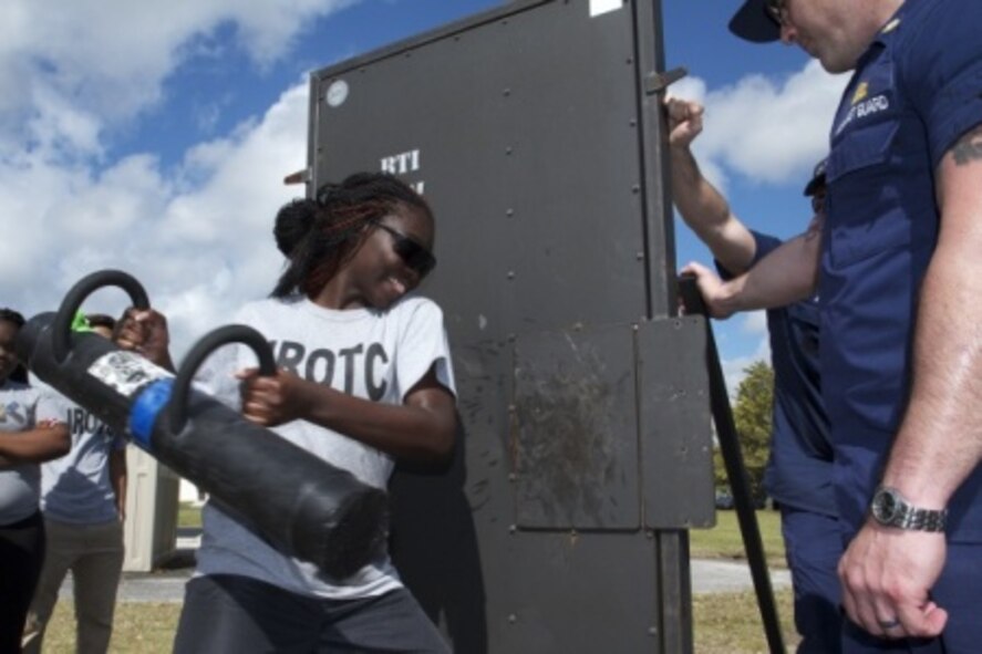 A Junior Reserve Officer Training Corps cadet from South Dade High School tries to breach a door open while working with a U.S. Coast Guard Maritime Safety Security Team member Jan. 22 during a two-day mentorship event as part of Special Operations Command South’s Military Assistance Program on Homestead Air Reserve Base, Fla. More than 180 cadets from Homestead High and South Dade High Schools participated in the event where the cadets got to see a local police dog demonstration, they interacted with members of the base’s explosive ordinance disposal (EOD) team and their equipment, and they observed an U.S. Air Force maintenance crew work on F-16 Falcon aircrafts. (U.S. Army photo by Staff. Agt. Osvaldo Equite)
