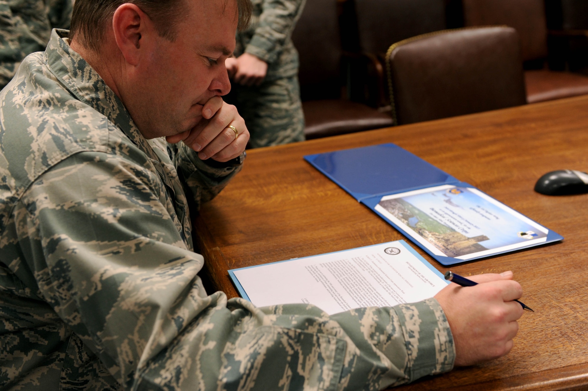 U.S. Air Force Col. Lars Hubert, 52nd Fighter Wing acting commander, reads a declaration of Biomedical Science Corps Week during a signing ceremony in the wing conference room at Spangdahlem Air Base, Germany, Jan. 21, 2015. The BSC, composed of 15 medical career fields, marks its 50th anniversary this year. (U.S. Air Force photo by Airman 1st Class Timothy Kim/Released)
