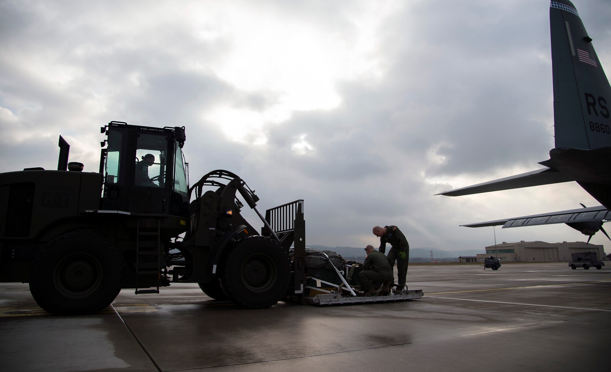 Loadmasters from the 37th Airlift Squadron ensure a bundle is properly secured prior to loading it into a C-130J Super Hercules at Ramstein Air Base, Germany, Jan. 20, 2015. Cargo loaded into an aircraft is carefully inspected by loadmasters and aerial delivery specialist to ensure the safety of the crew. (U.S. Air Force photo/Senior Airman Damon Kasberg)