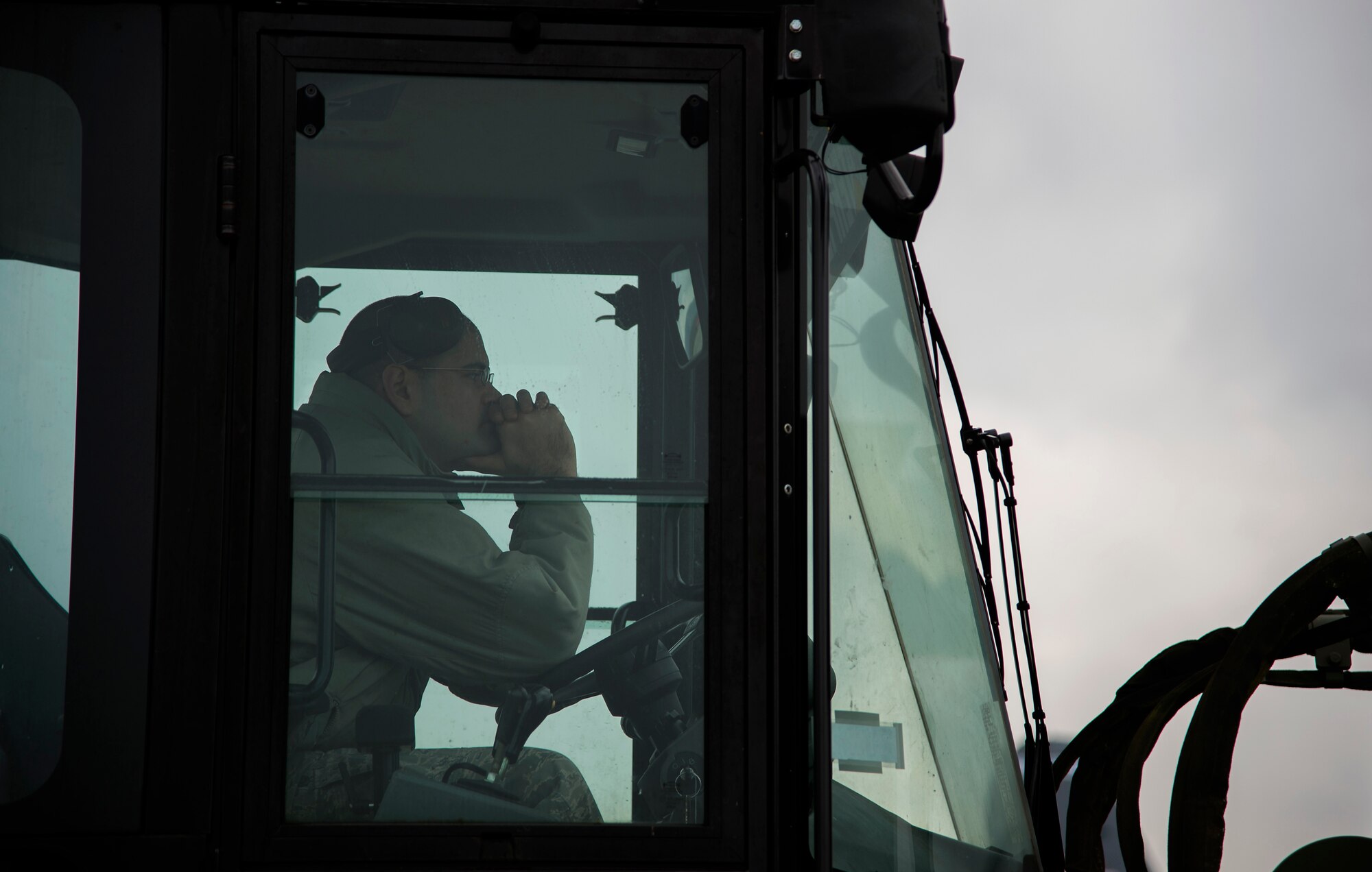 Staff Sgt. Brantley Roberson, 86th Logistics Readiness Squadron aerial delivery supervisor, waits as Airmen prepare a C-130J Super Hercules to take in cargo at Ramstein Air Base, Germany, Jan. 20, 2015. Members of the 86th LRS aerial delivery assist the 37th Airlift Squadron with their airdrop training by providing a variety of training bundles from heavy platforms to container deployment systems. (U.S. Air Force photo/Senior Airman Damon Kasberg)