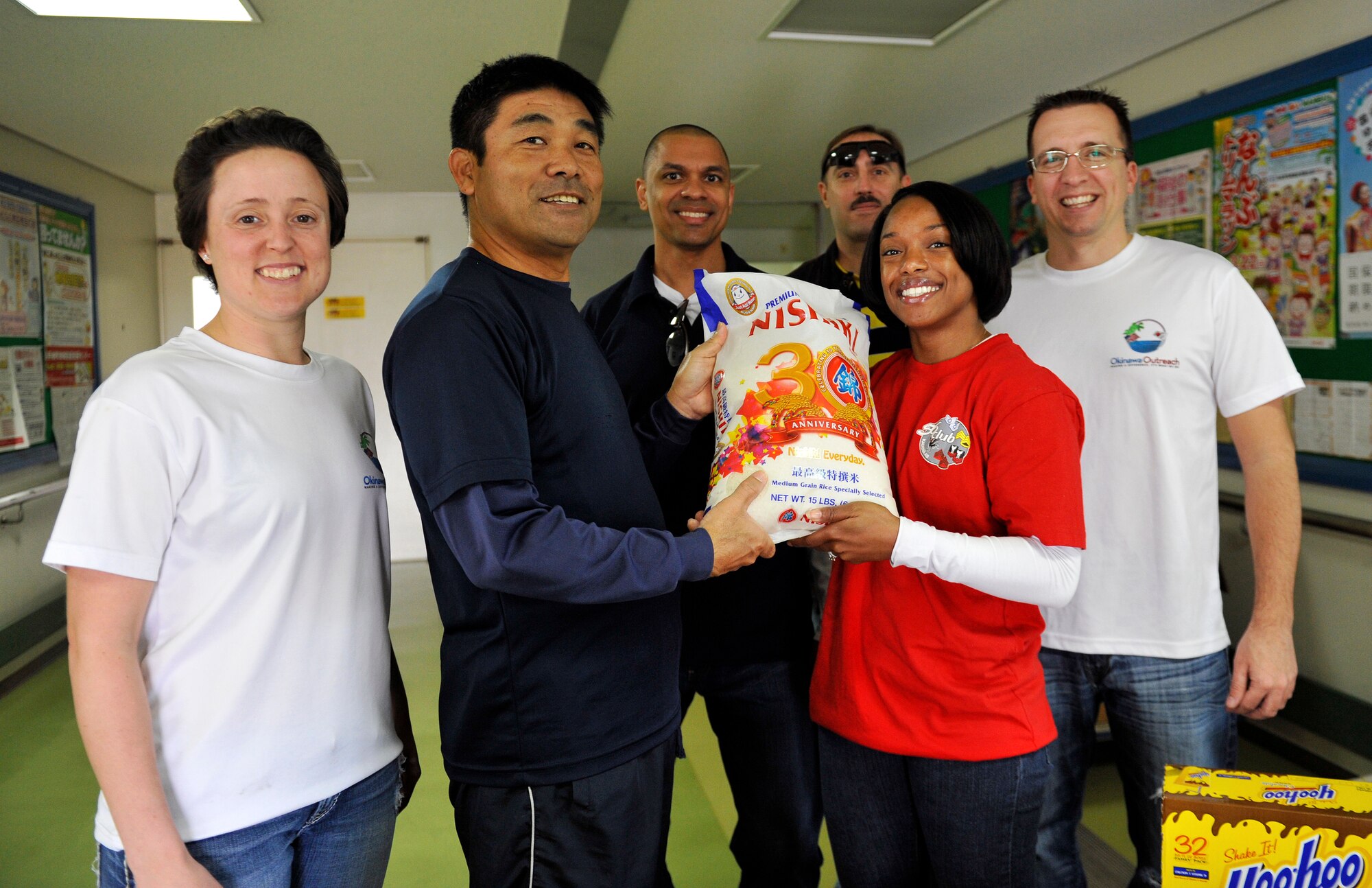 Moriyasu Yonashiro, Kadena Welfare Center executive director, and members from the Kadena Outreach Committee pose for a photo at the Kadena welfare center, Okinawa, Japan, Jan. 23, 2015. The Okinawa Outreach Committee collected thousands of food and toiletry donations over the last two months. These donations will be delivered by Kadena Top 3 to Kadena Town, Chatan Town and Okinawa City welfare centers. (U.S. Air Force photo by Naoto Anazawa)
