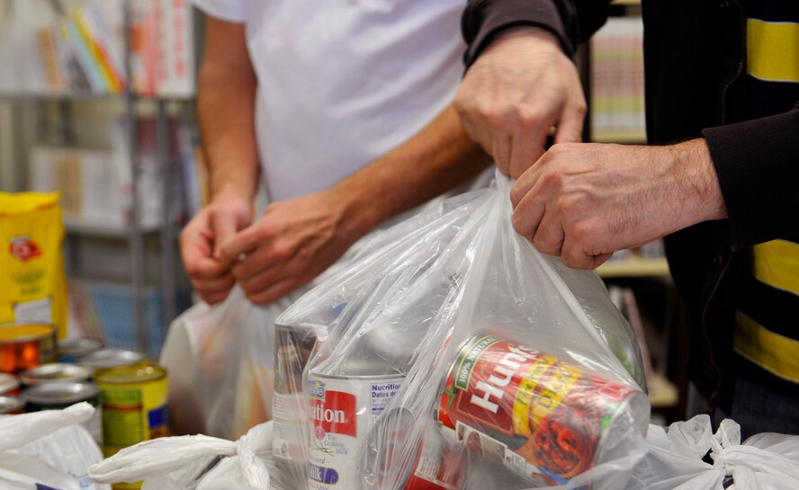 Members from Okinawa Outreach Committee organize donations at the Okinawa City welfare center, Okinawa, Japan, Jan. 23, 2015. Volunteers from the Kadena Air Base Top 3 program participated in the Okinawa Outreach Committee food drive. They helped organize and transport thousands of donated food items to three different outreach sites. (U.S. Air Force photo by Naoto Anazawa)