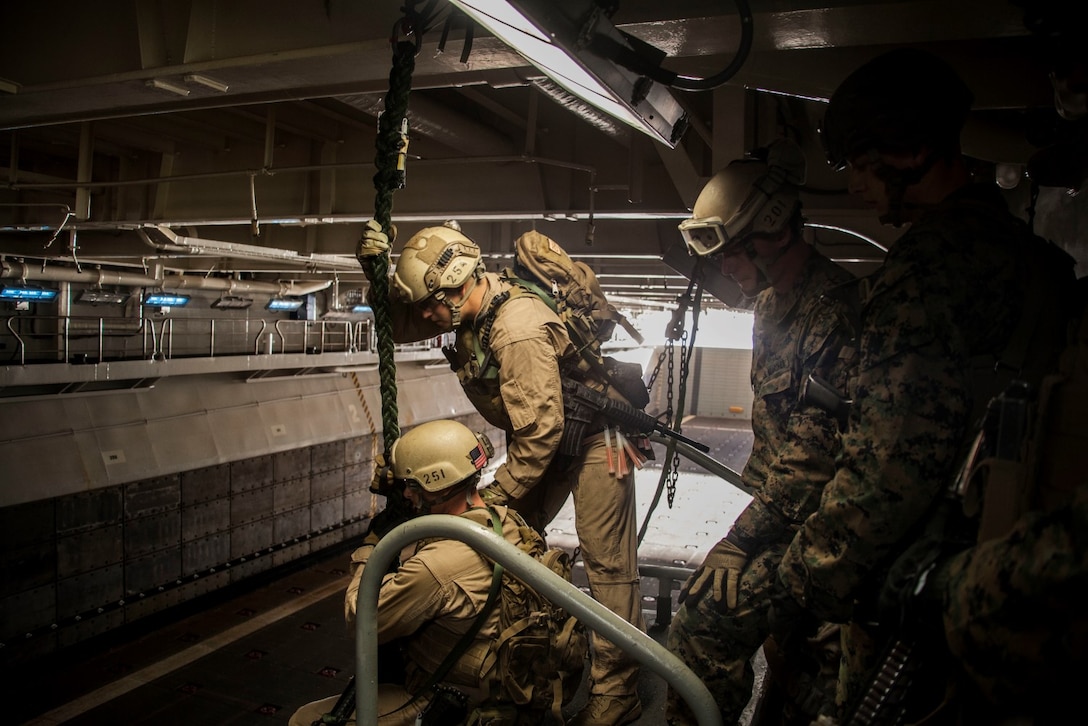 U.S. Marines from the 15th Marine Expeditionary Unit's Maritime Raid Force practice fast-roping procedures in the well deck of USS Essex (LHD 2) at Naval Base San Diego Jan. 24, 2015. The 15th MEU was embarked aboard the three ships of the Essex Amphibious Ready Group - the USS Essex, USS Anchorage (LPD 23), and USS Rushmore (LSD 47) – to familiarize themselves with the ships as they continue to prepare for their upcoming deployment this spring. (U.S. Marine Corps photo by Cpl. Elize McKelvey/Released)