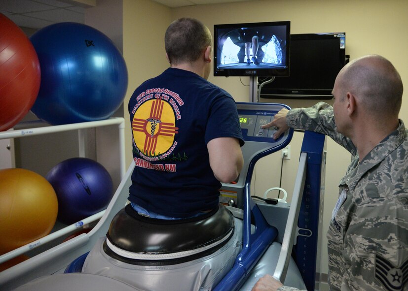 U.S. Air Force Tech. Sgt. John Welch, 27th Special Operations Medical Operations Squadron, programs an anti-gravity treadmill for a patient Jan. 21, 2015 at Cannon Air Force Base, N.M. The machine inflates to lower body weight, removing impact for patients who experience pain during normal running. (U.S. Air Force photo/Staff Sgt. Alexxis Mercer) 