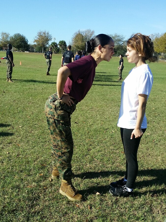 Staff Sgt Danielle Handy, a drill instructor with 4th Battalion, Marine Corps Recruit Depot South Carolina, motivates a poolee during the Recruiting Station Orlando female pool function Jan. 17, 2015. The pool function teaches future Marines what will be expected of them during recruit training. 