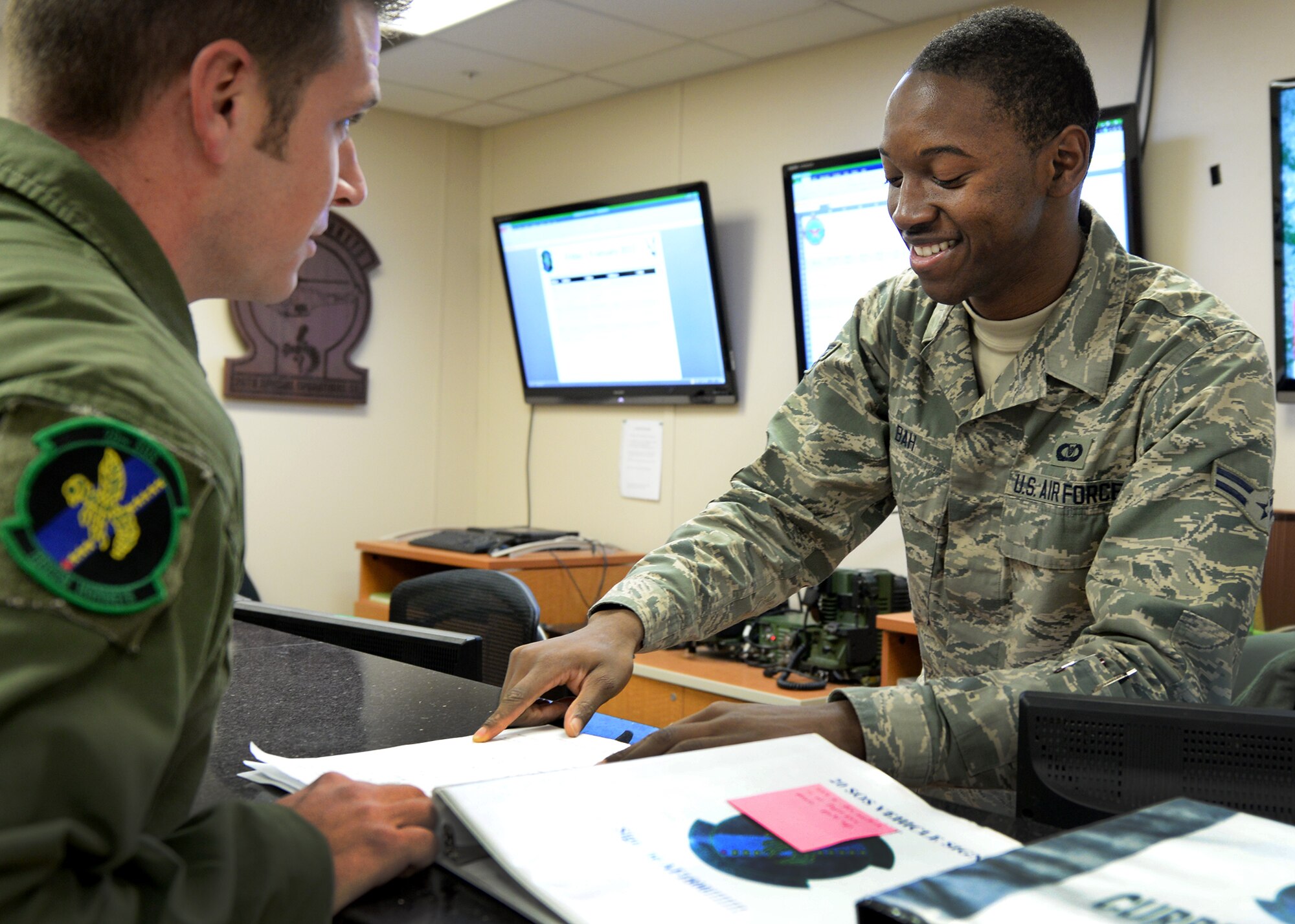 A member of the 27th Special Operations Group Squadron Aviation Resource Management office goes over qualification updates with a fellow Air Commando Jan. 9, 2015 at Cannon Air Force Base, N.M. The 27th SOG was recently announced the winners of the 2014 Aviation Resource Management Awards for large unit. (U.S. Air Force photo/Airman 1st Class Chip Slack)