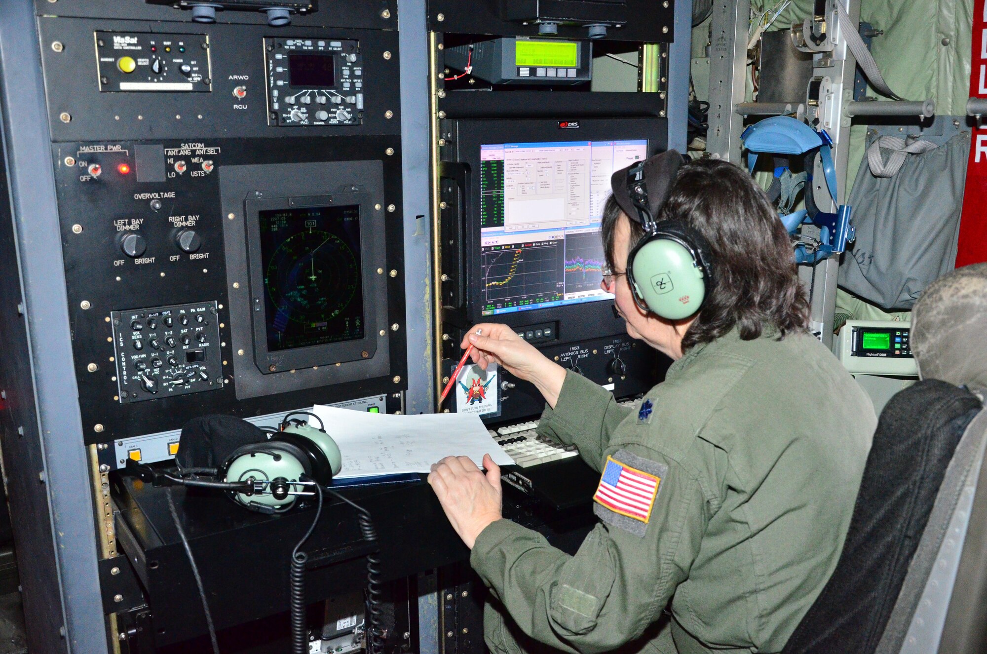 Lt. Col. Valerie Hendry, an aerial reconnaissance weather officer with the 53rd Weather Reconnaissance Squadron checks data during winter storm "Iola" 23 Jan. (U.S. Air Force Photo/Master Sgt. Brian Lamar) 
