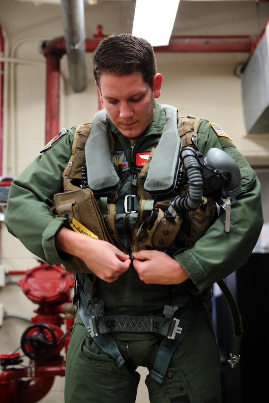 Air Force Capt. Jason D. Larish dons flight equipment before a flight with Marine Tactical Electronic Warfare Training Squadron 1 at Marine Corps Air Station Cherry Point, N.C., Jan. 20, 2015. Larish is taking part in an inter-service exchange program to introduce officers from different military branches to other services’ operational capabilities. Originally a member of the Air Force’s 55th Electronic Combat Group, Larish now trains with VMAQT-1 and is learning to operate as an electronic countermeasure officer in an EA-6B Prowler. Larish is a native of Buffalo, N.Y.