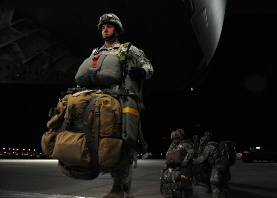 A Texas Army National Guard Soldier from the 1st Battalion, 143rd Infantry Regiment walks up the cargo ramp of a U.S. Air Force C-17 Globemaster III cargo aircraft in Austin, Texas, Jan. 23, 2015. Many of the Soldiers gear weighed up to 95 pounds. (U.S. Air Force photo by Airman 1st Class Nathan Clark)