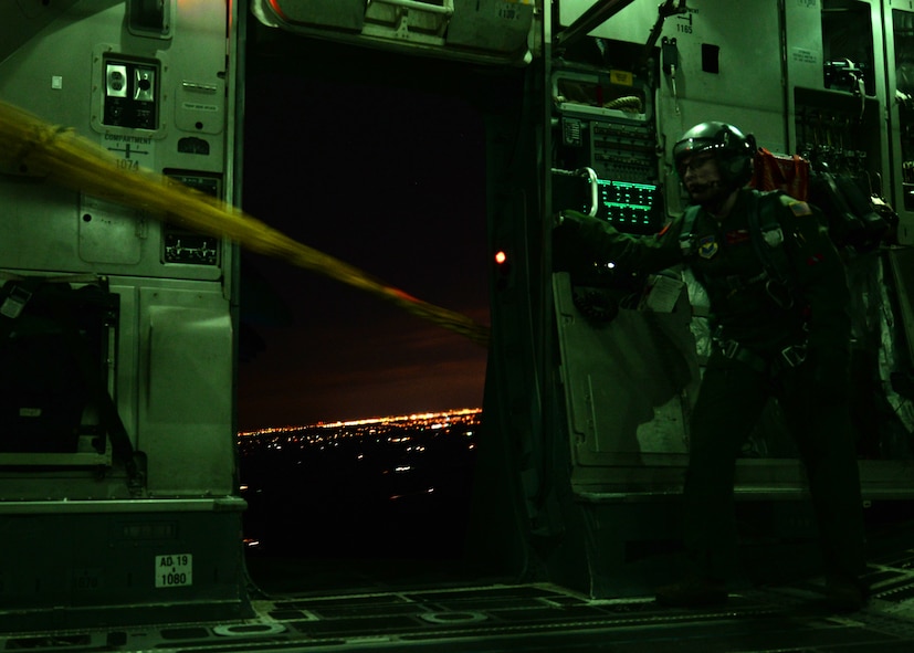 Staff Sgt. Laura Bourdlais, C-17 Globemaster III cargo aircraft loadmaster with the 58th Airlift Squadron reels in empty lines from paratroopers’ deployed parachutes near San Antonio, Texas, Jan. 23, 2015. Loadmasters use a winch system when pulling in more than 10 lines. The Soldiers jumped from the aircraft using a static line method which deploys their chutes immediately as they exit the aircraft. (U.S. Air Force photo by Airman 1st Class Nathan Clark)
