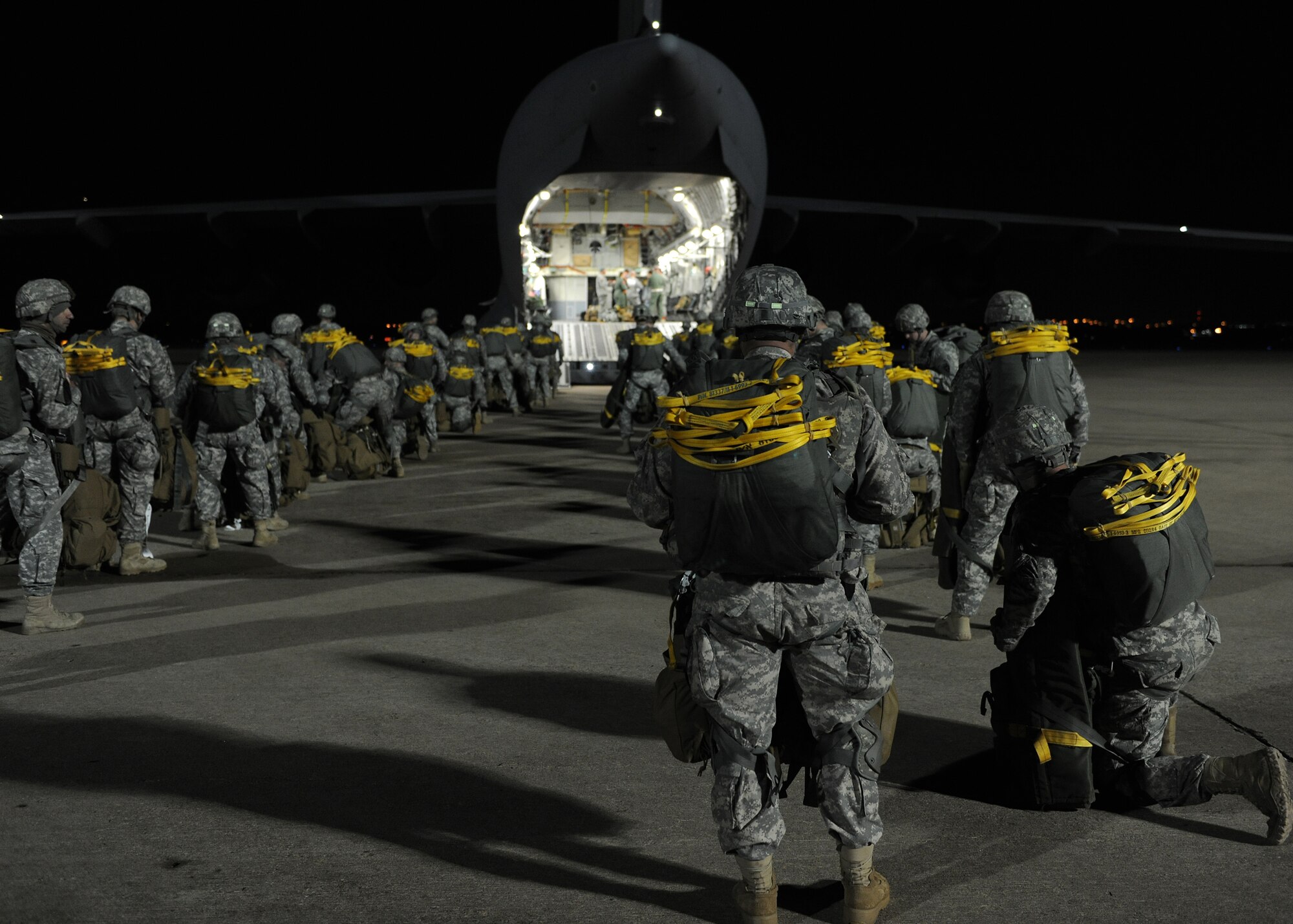 Texas Army National Guard Soldier from the 1st Battalion, 143rd Infantry Regiment load into a U.S. Air Force C-17 Globemaster III cargo aircraft in Austin, Texas, Jan. 23, 2015. The joint exercise benefited U.S. Air Force loadmasters and National Guard paratroopers by helping them keep their proficiency of executing static line jumps. (U.S. Air Force photo by Airman 1st Class Nathan Clark)