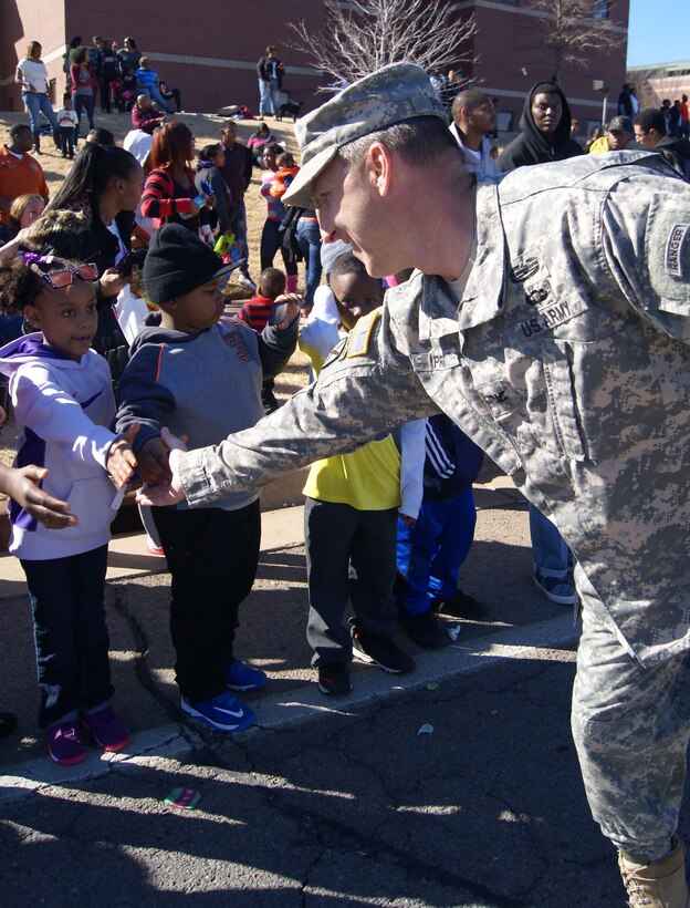 Col. Richard A. Pratt, commander, Tulsa District U.S. Army Corps of Engineers, shakes hands with spectators during the Martin Luther King Jr., Memorial Parade, Jan. 19. Members of the Tulsa District participated in the parade in Tulsa.