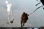 SYLHET INTERNATIONAL AIRPORT, Bangladesh (Jan. 24, 2015) - Bangladeshi commandos jump from a U.S. Air Force C-130H aircraft over a drop zone during Exercise COPE SOUTH near Sylhet.  COPE SOUTH helps cultivate common bonds, foster goodwill and improve readiness and compatibility between members of the Bangladesh and U.S. Air Forces. 