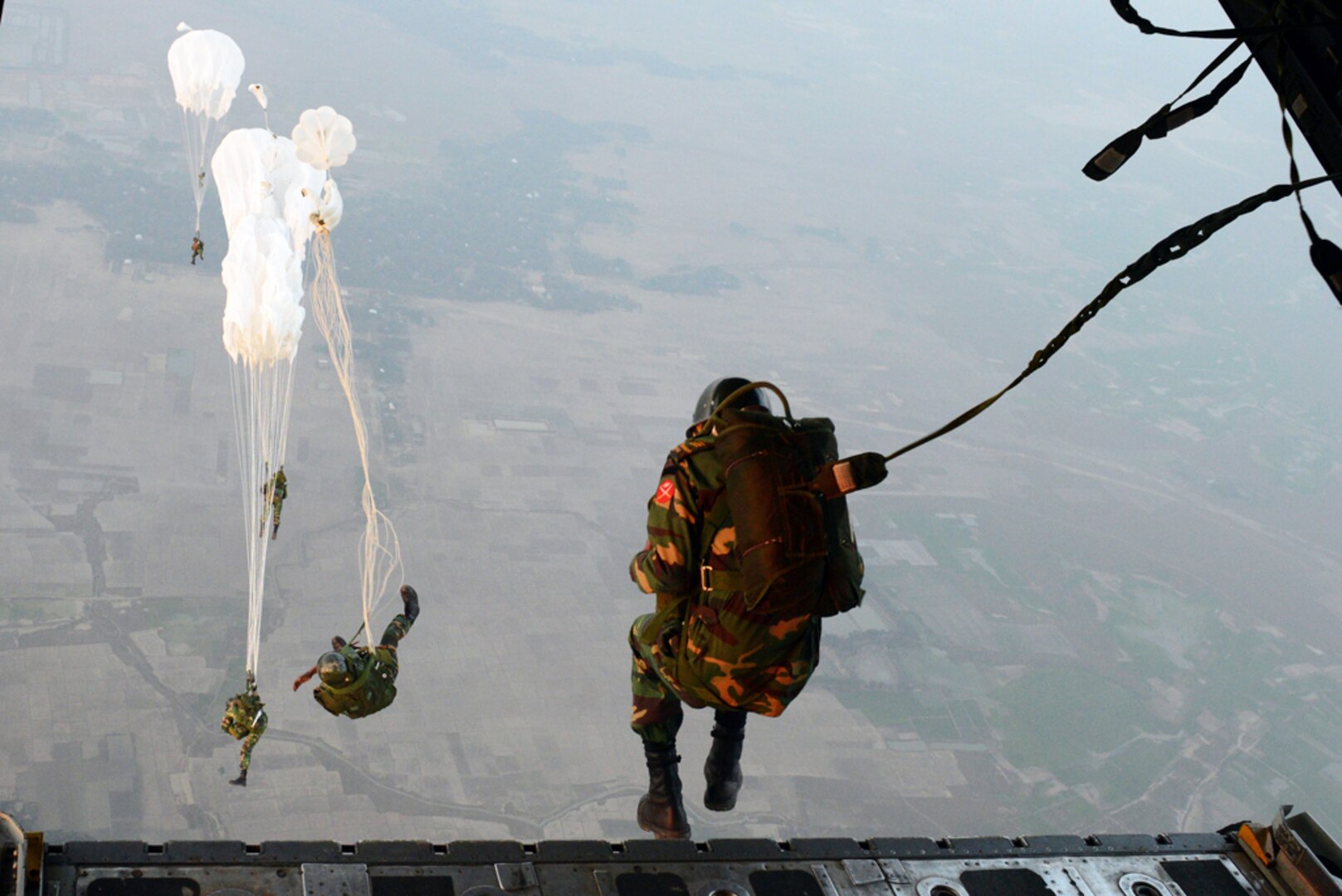 SYLHET INTERNATIONAL AIRPORT, Bangladesh (Jan. 24, 2015) - Bangladeshi commandos jump from a U.S. Air Force C-130H aircraft over a drop zone during Exercise COPE SOUTH near Sylhet.  COPE SOUTH helps cultivate common bonds, foster goodwill and improve readiness and compatibility between members of the Bangladesh and U.S. Air Forces. 