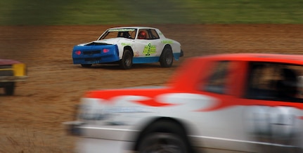 Sgt. Nicholas Adams, the non-commissioned officer in
charge of Outdoor Recreation at Camp Atterbury Joint Maneuver Training
Center in Indiana speeds around a corner in the third lap during a pure
stock race at Brownstown Speedway May 8, 2010.