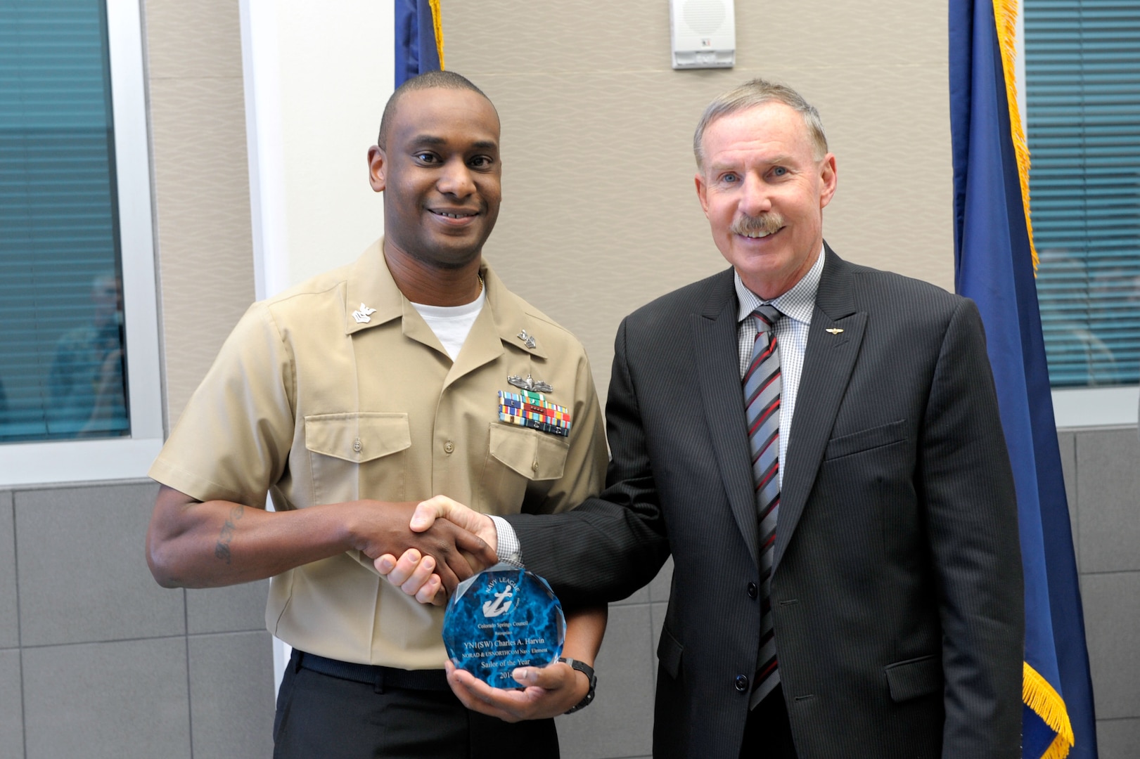 Representatives from the Colorado Springs Council of the Navy League recognized North American Aerospace Defense Command and U.S. Northern Command’s Sailor of the Year during a ceremony here Jan. 27. Council President Capt. (U.S. Navy ret.) Roy Rodgers presents Petty Officer First Class Charles Harvin with a plaque in honor of his award. Harvin now competes with other combatant command nominees.