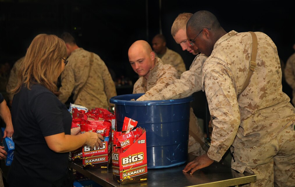 A USO volunteer serves Marines snacks during a free showing of ‘American Sniper’ at Camp Wilson, Jan. 21. The United Services Organization, Single Marine Program, Marine Corps Community Services and Camp Wilson personnel hosted the movie premier to help boost the Marines and sailors morale before the start of Integrated Training Exercise 2-15. 