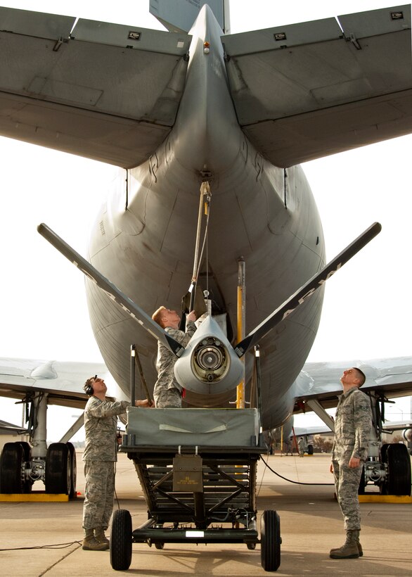 Staff Sgt. Edward Porter, 362nd Training Squadron instructor, teaches Airman Connor Harbuck and Airman 1st Class Jake Bumbaca, 362nd Training Squadron students, how to install and remove a boom sling. A boom sling is used to ensure the air refueling boom does not fall due to hydraulic or electrical power failures. (U.S. Air Force photo by Danny Webb/Released)
