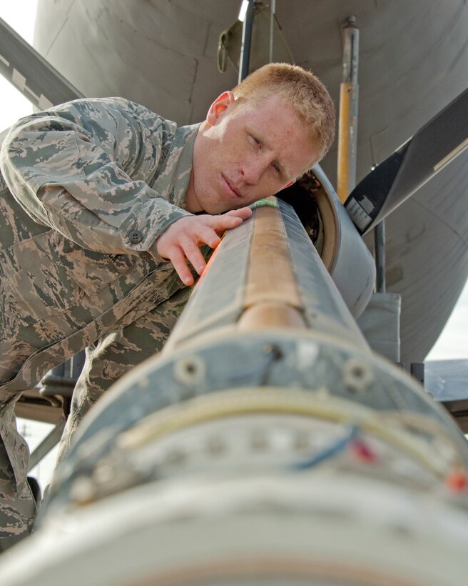 Airman Connor Harbuck, 362nd Training Squadron, inspects the refueling boom sling to a KC-135 Stratotanker during an inspection Jan. 19, 2015. A boom sling is used to ensure the air refueling boom does not fall due to hydraulic or electrical power failures. (U.S. Air Force photo by Danny Webb/Released)

