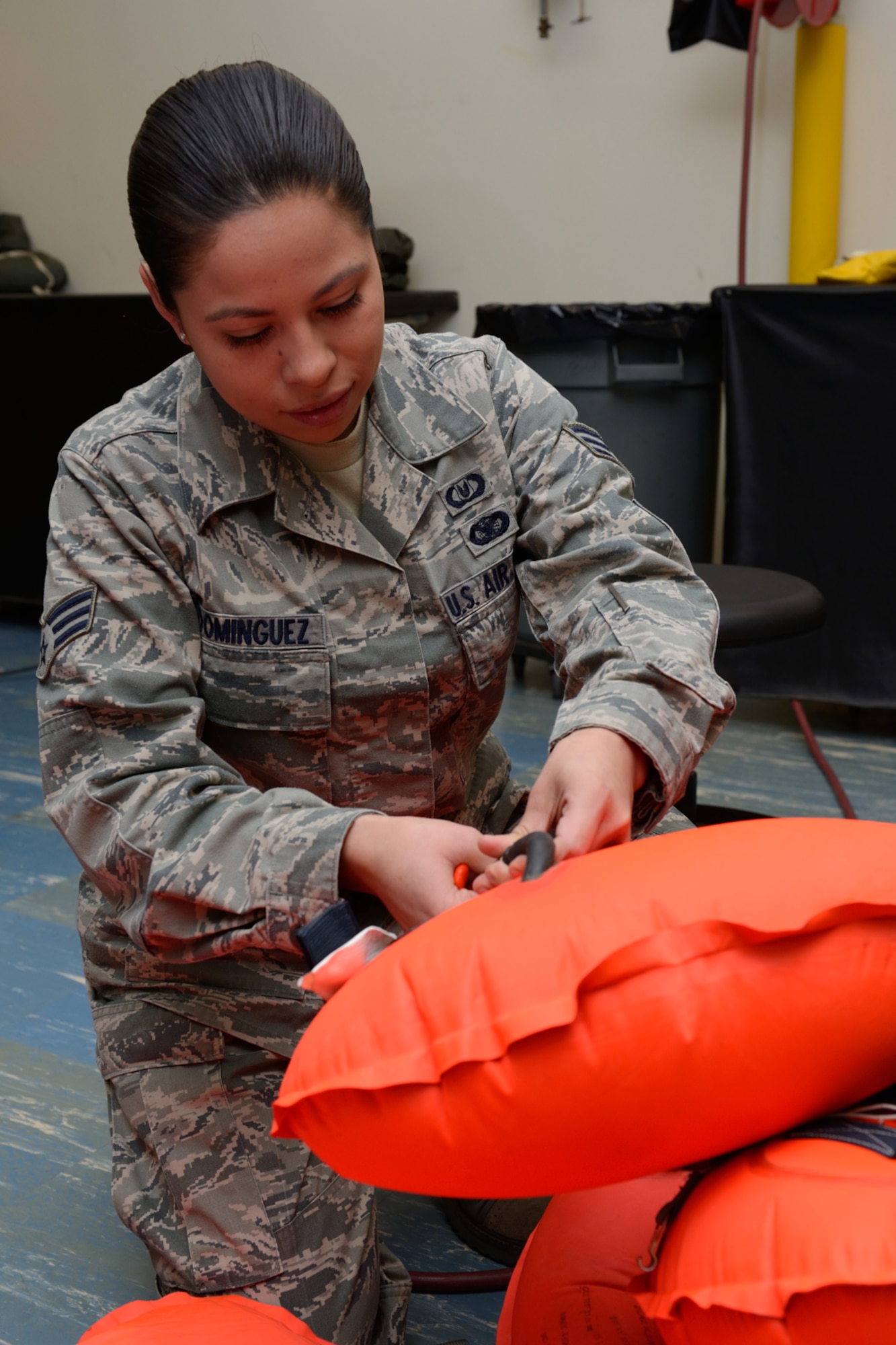 Senior Airman Jamie Dominguez, 403rd Operations Support Squadron aircrew flight equipment journeyman, inflates an LPU-10P life preserver to check its air pressure and inspect it for leaks January 10, 2015. The 403rd OSS provides training, information and equipment support for aircrew members of the 53rd Weather Reconnaissance Squadron, and 815th Airlift Squadrons, all of which are assigned to the 403rd Wing at Keesler Air Force Base, Mississippi. (U.S. Air Force photo/Tech. Sgt. Ryan Labadens)