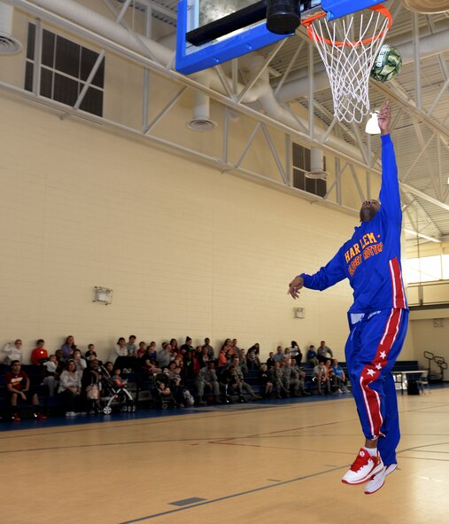 Flight Time, Harlem Globetrotter point guard, demonstrates his basketball skills at the Senior Airman Bryan R. Bell Fitness Center on Barksdale Air Force Base, La., Jan. 26, 2015. Flight Time, a 16-year member of the team, met with Airmen to boost morale and signed autographs. (U.S. Air Force photo/Airman 1st Class Curt Beach)