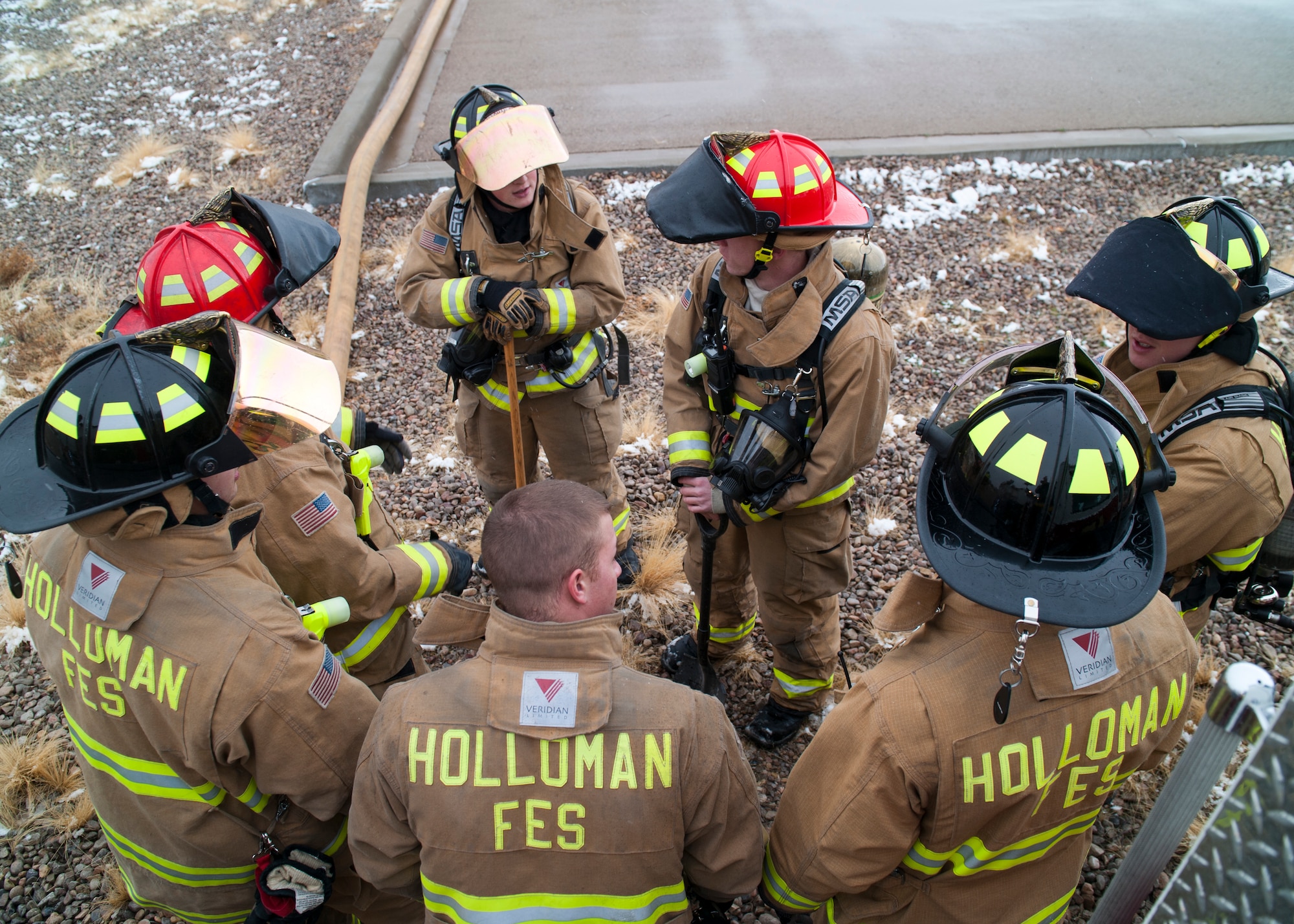 Members of the 49th Civil Engineering Squadron Fire Protection Flight don protective attire in preparation for a POL fuel leak training exercise at Holloman Air Force Base, N.M., Jan. 22. Firefighters from the 49th CES performed a series of procedures to secure the area and maintain the simulated fire. (U.S. Air Force photo by Senior Airman Colin Cates/Released)
