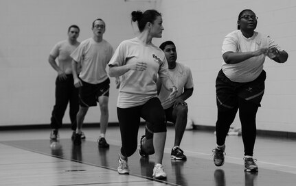 U.S. Air Force Staff Sgt. Cristina Sullivan, 633rd Force Support Squadron Back 2 Basics lead instructor, works with individuals during a B2B class at Langley Air Force Base, Va., Jan. 8, 2015. B2B is a fitness improvement program aimed at assisting Airmen with 80% or lower on their Air Force physical fitness assessments. (U.S. Air Force photo by Senior Airman Kayla Newman/Released) 
