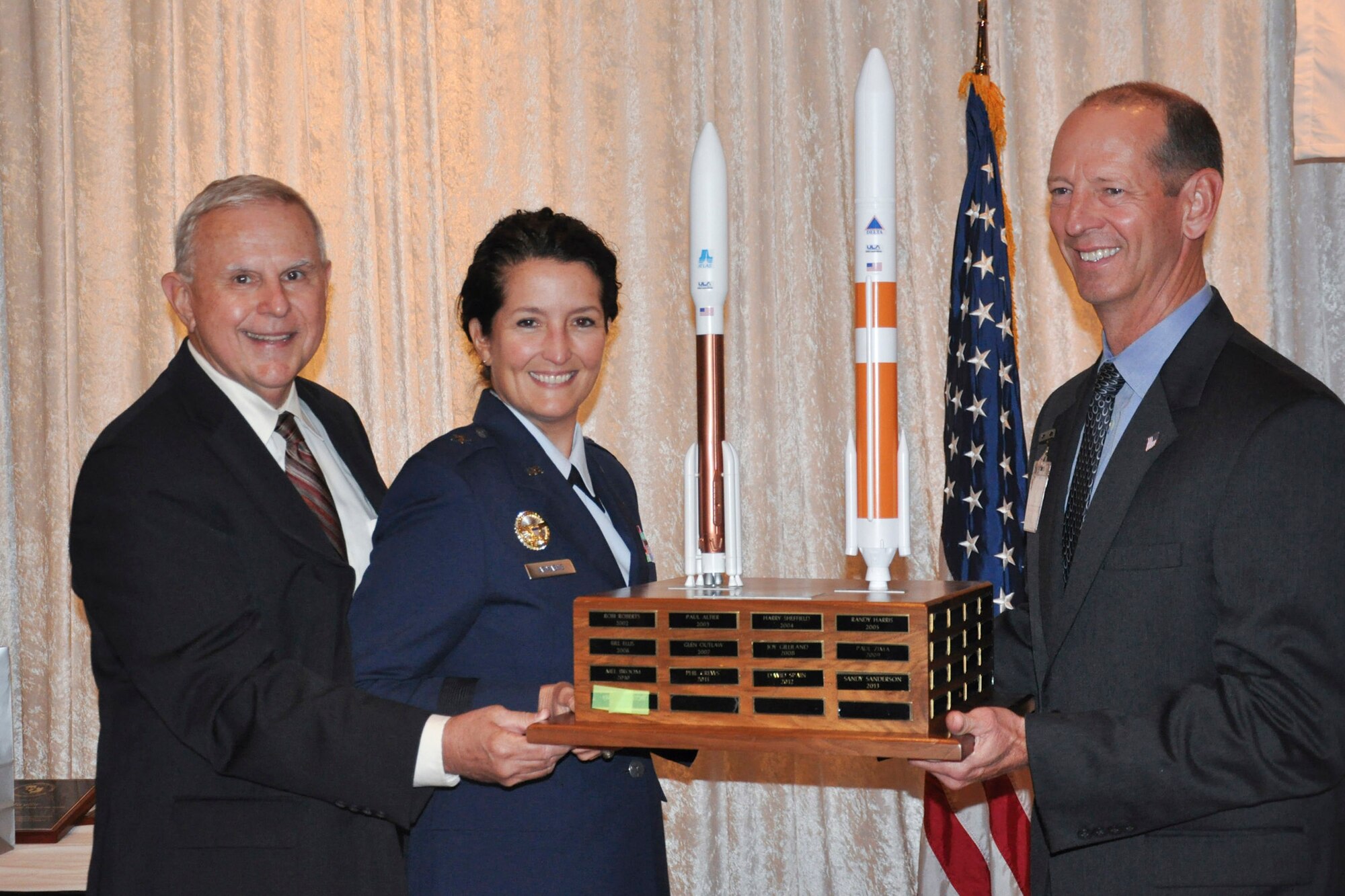 Norm Wolfinger, Civilian Military Community Relations Council chairman, and

Brig. Gen. Nina Armagno, 45th Space Wing commander, present the 2014 Civ-Mil

Member of the Year Trophy to Keith Houston at the annual Commander's

Civilian Military Community Relations Council Banquet, Jan. 24 at the Tides.

Houston was recognized for his efforts as the chair of the golf tournament

and his outstanding contributions to Civ-Mil.
